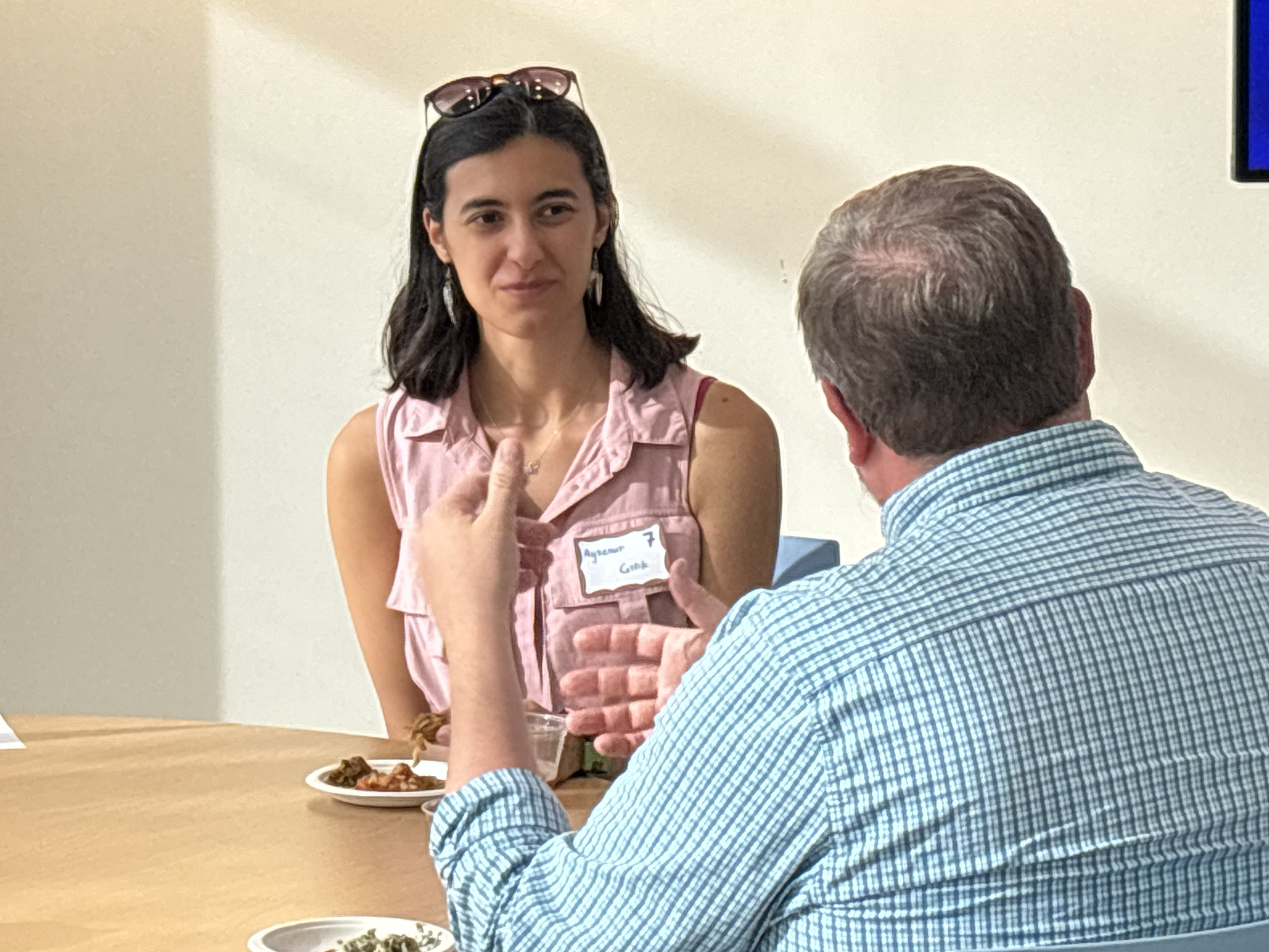 A woman listening to a man speak at a table