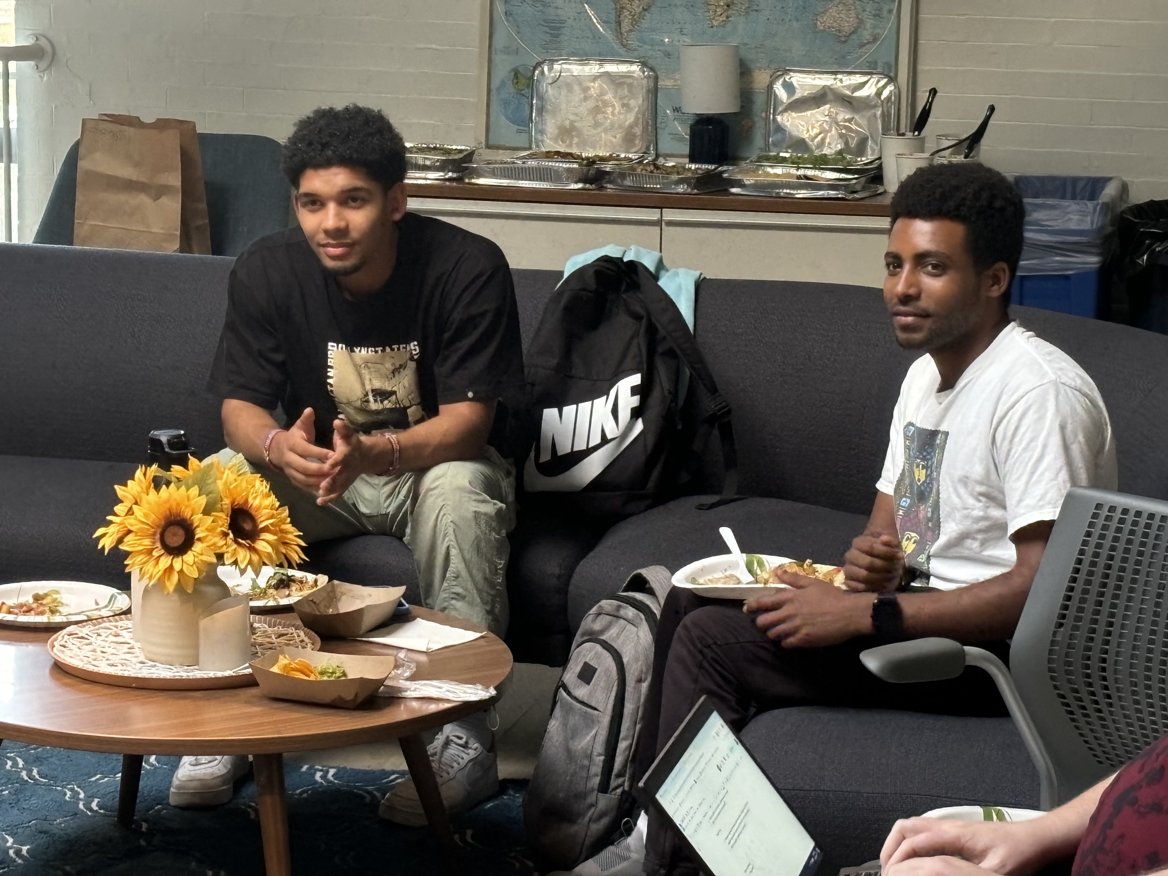 Two college students speaking in a student lounge