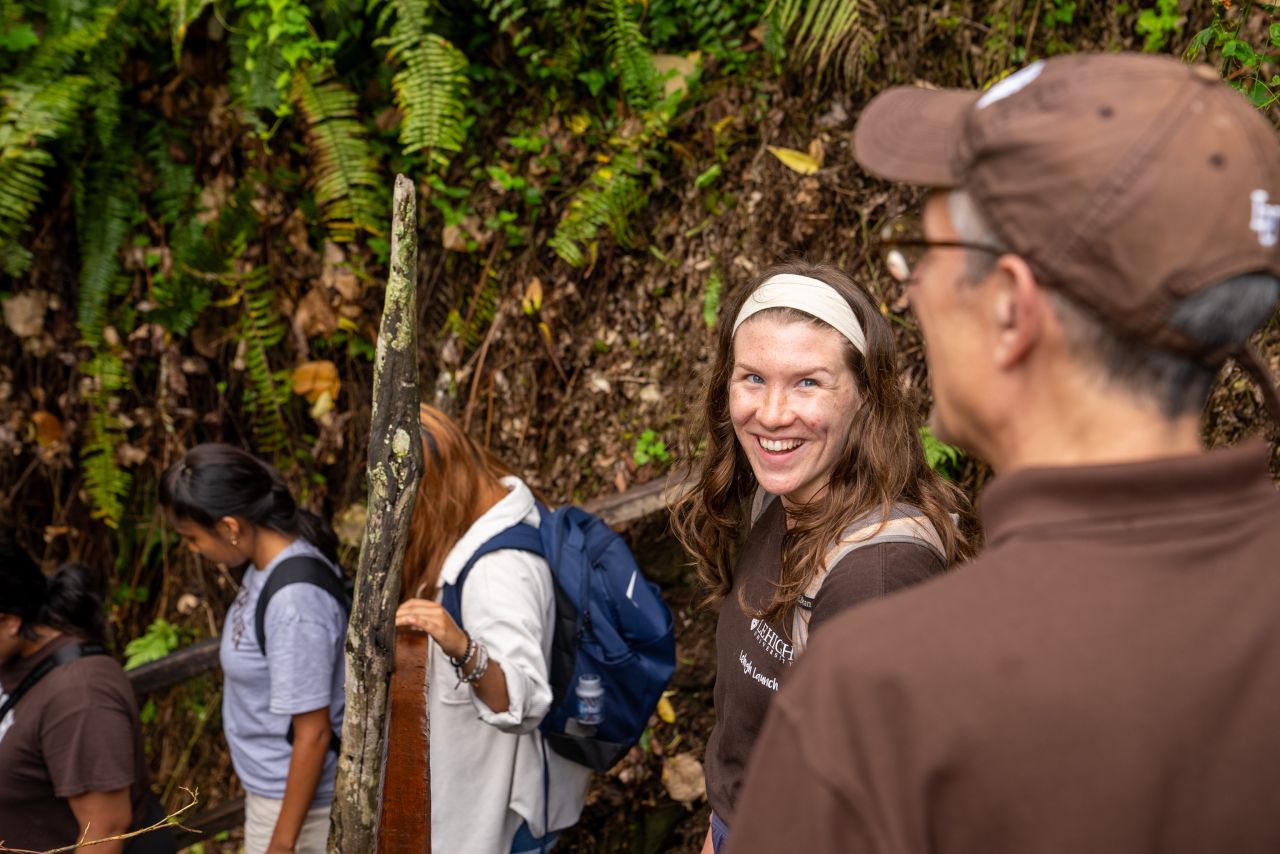 Lehigh University students and university President Joseph Helble walking in the forest together