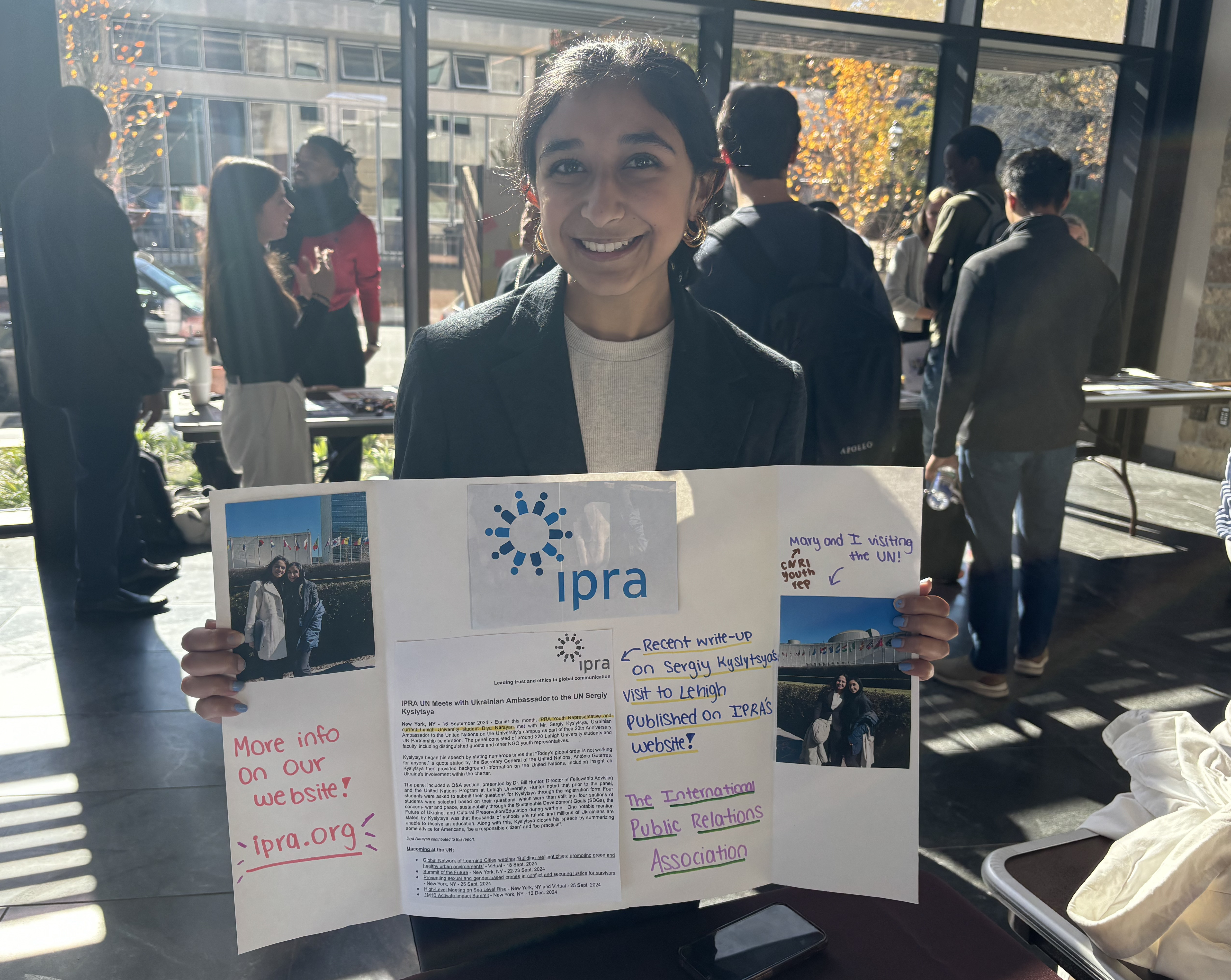 Diya Narayan holding a board with information on it