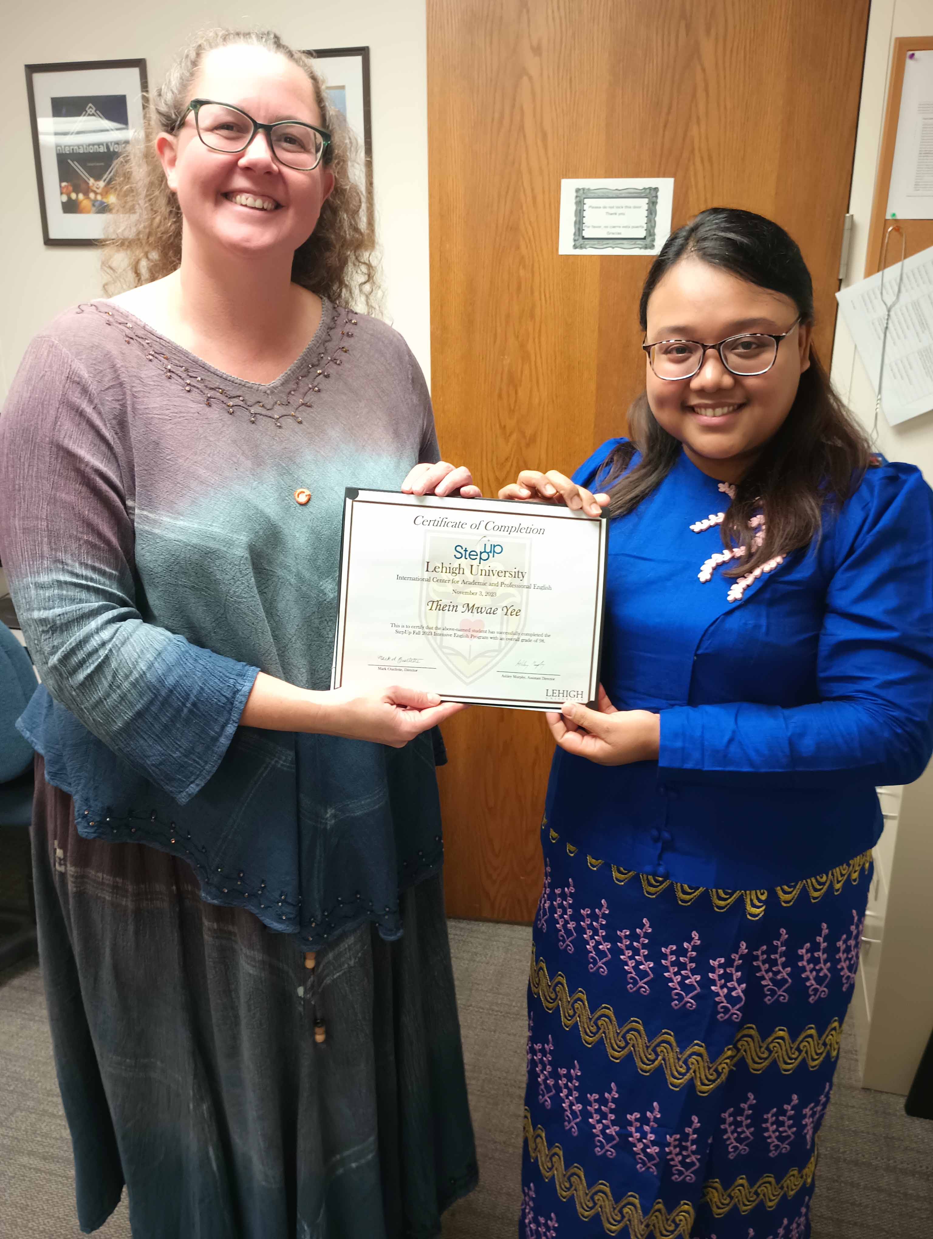 Ashley Murphy giving a certificate to Thein Mwae in a Lehigh University classroom
