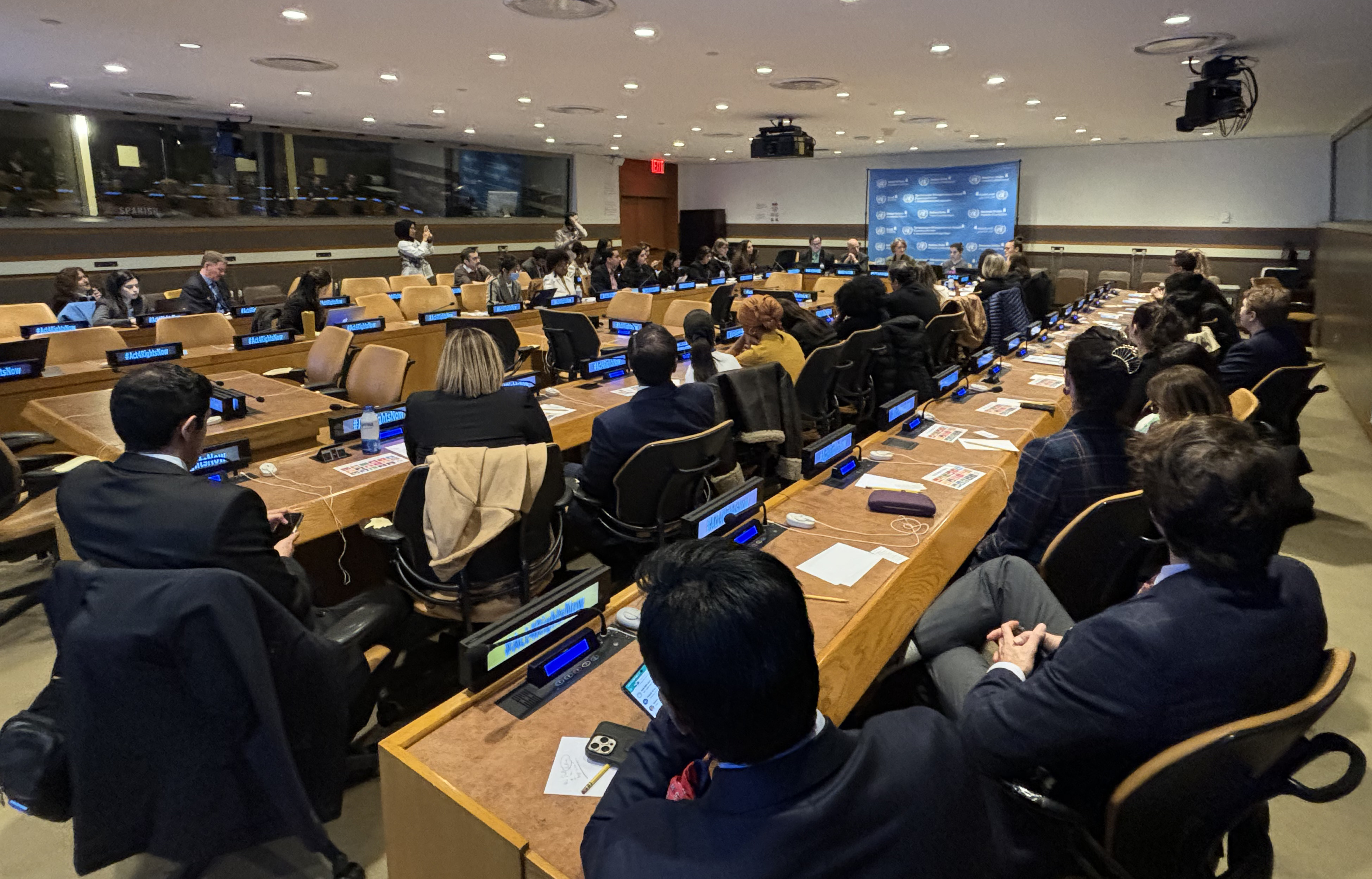 People sitting at tables in a United Nations conference room