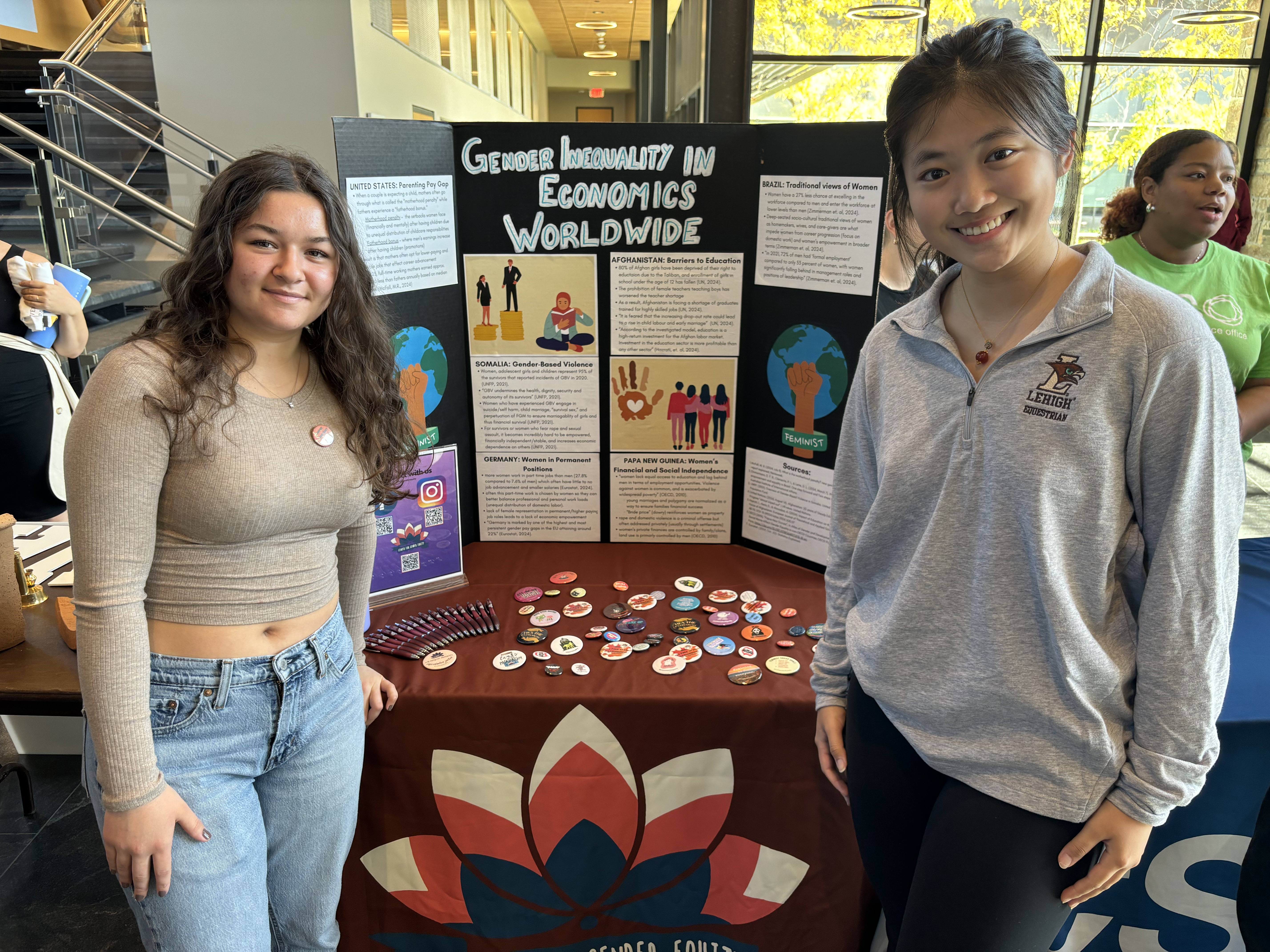 Two students at an information panel representing the Lehigh University Center for Gender Equity