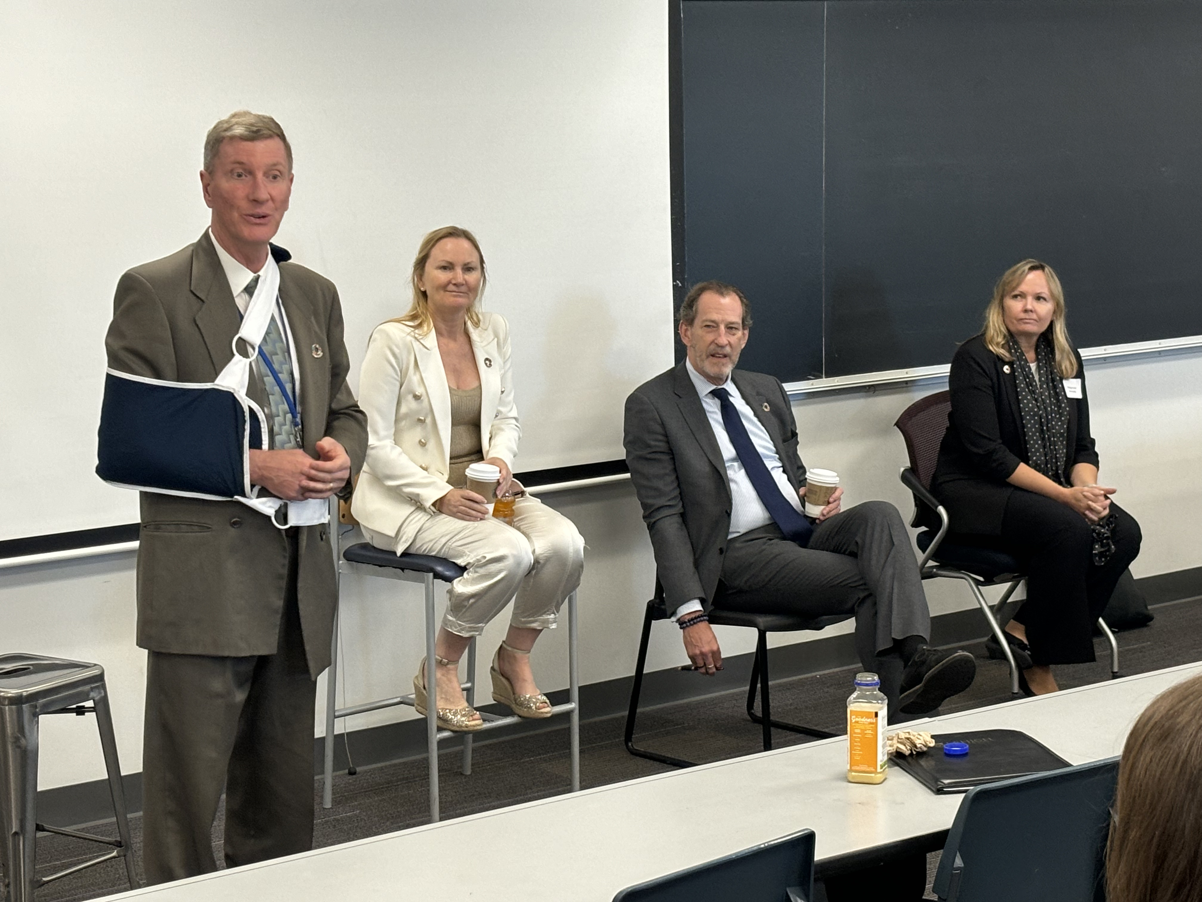 Four people speaking at a panel discussion