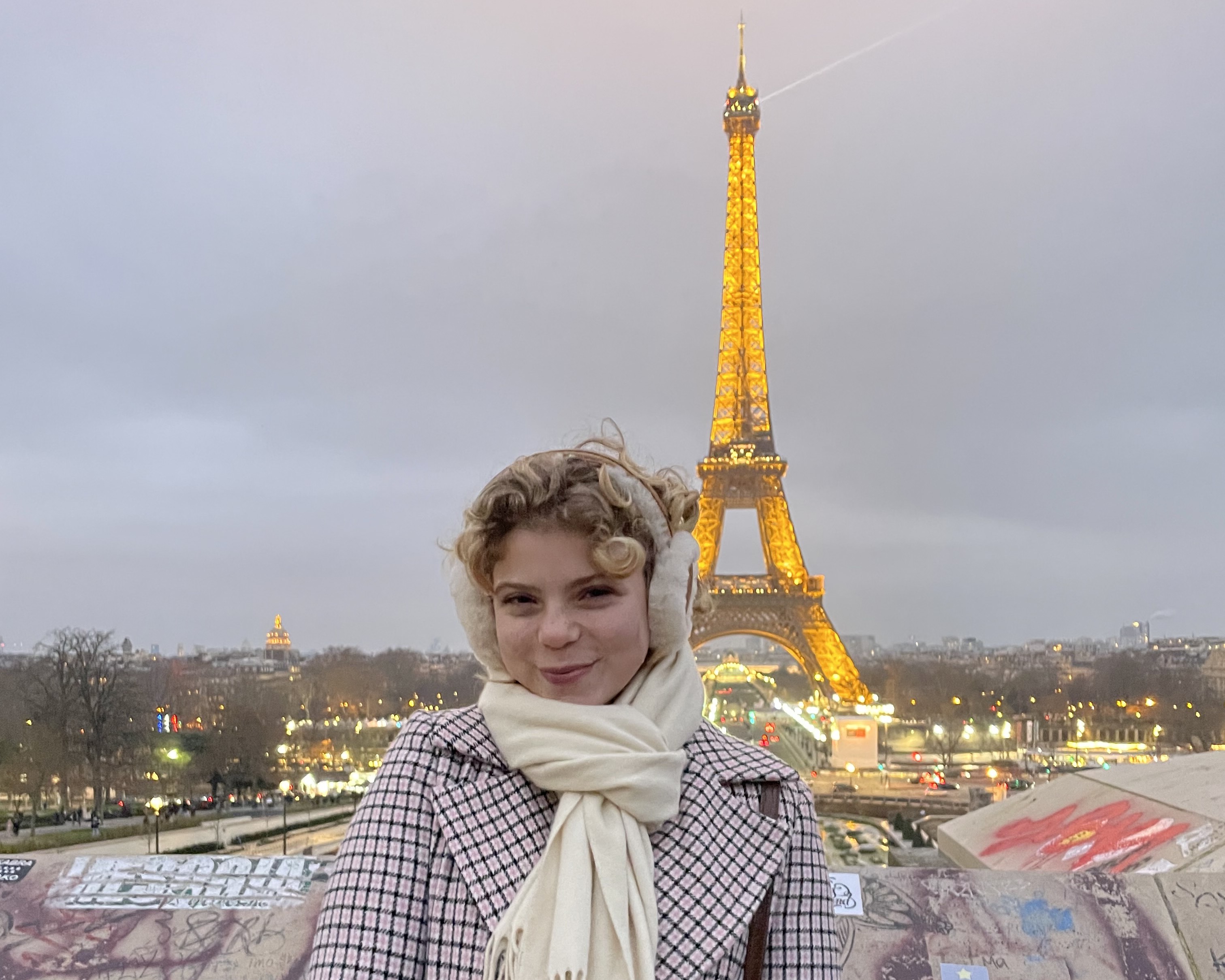 Liana Secondino standing in front of the Eiffel Tower in paris