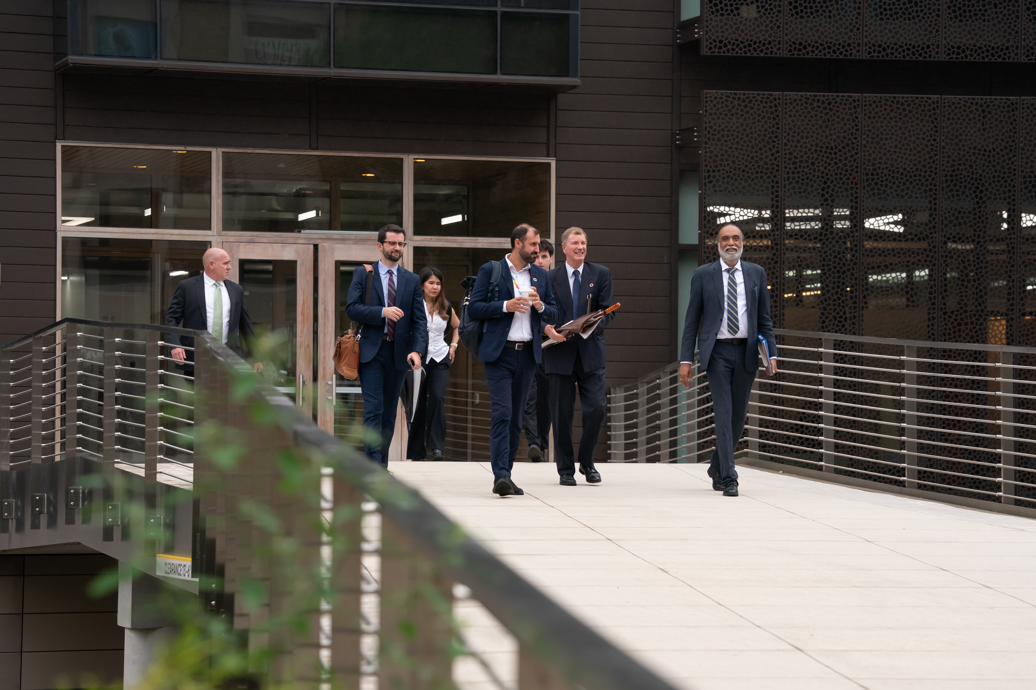 A group of people walking on campus