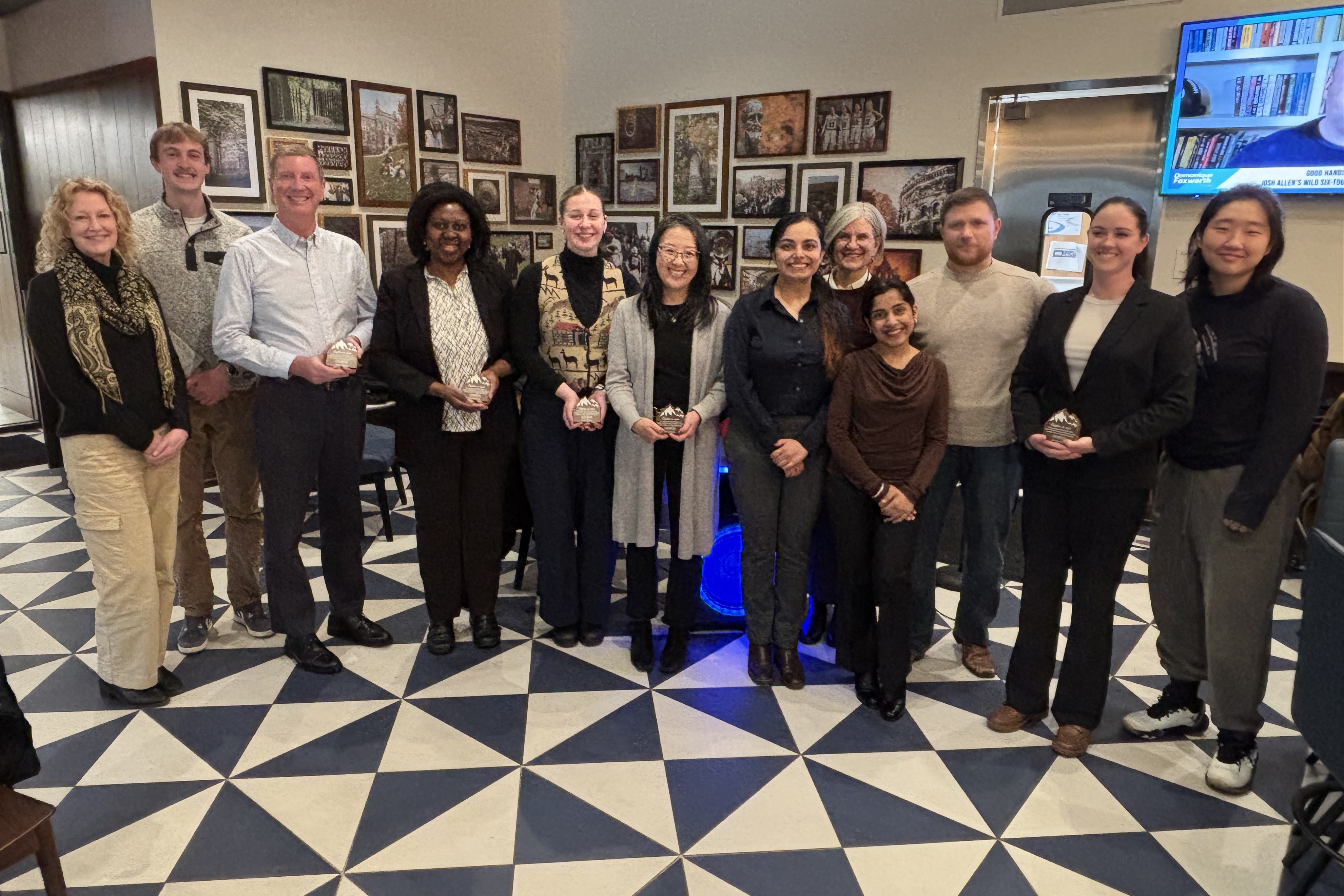 A group of people posing for a photo in a restaurant