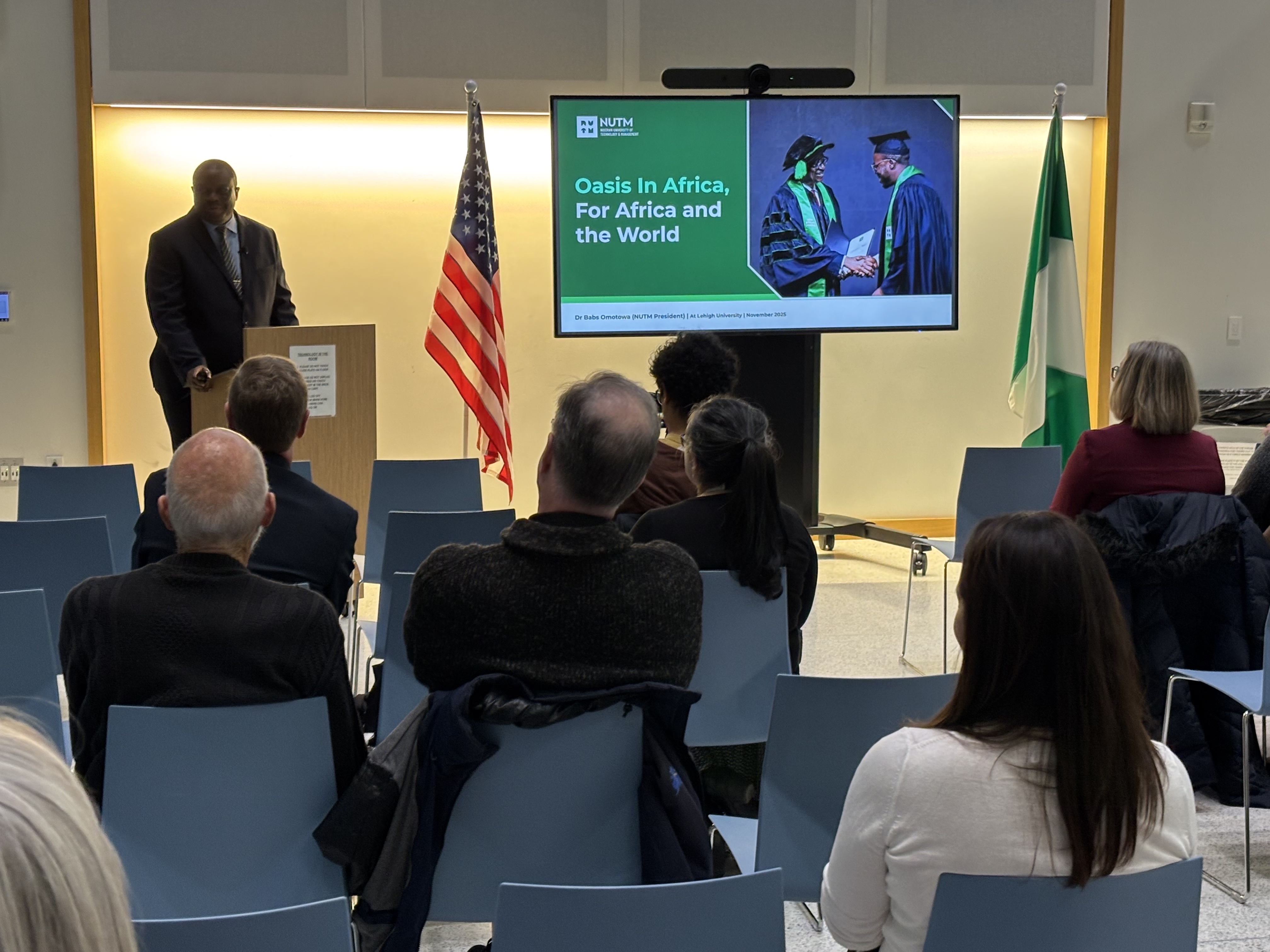 A man speaking at a podium to a crowd