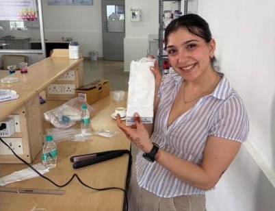 A young woman holding a menstrual pad