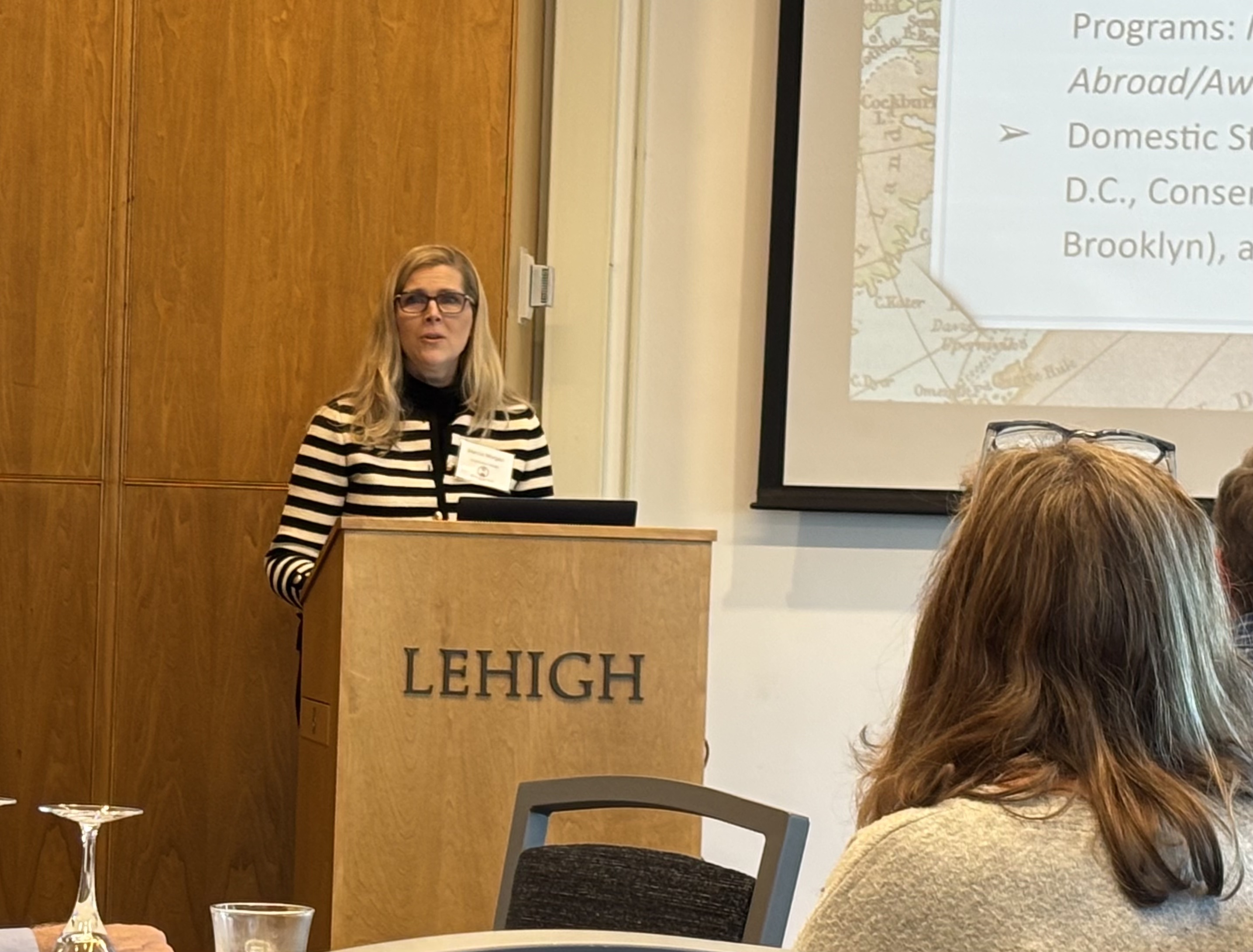 A woman standing at a podium and speaking