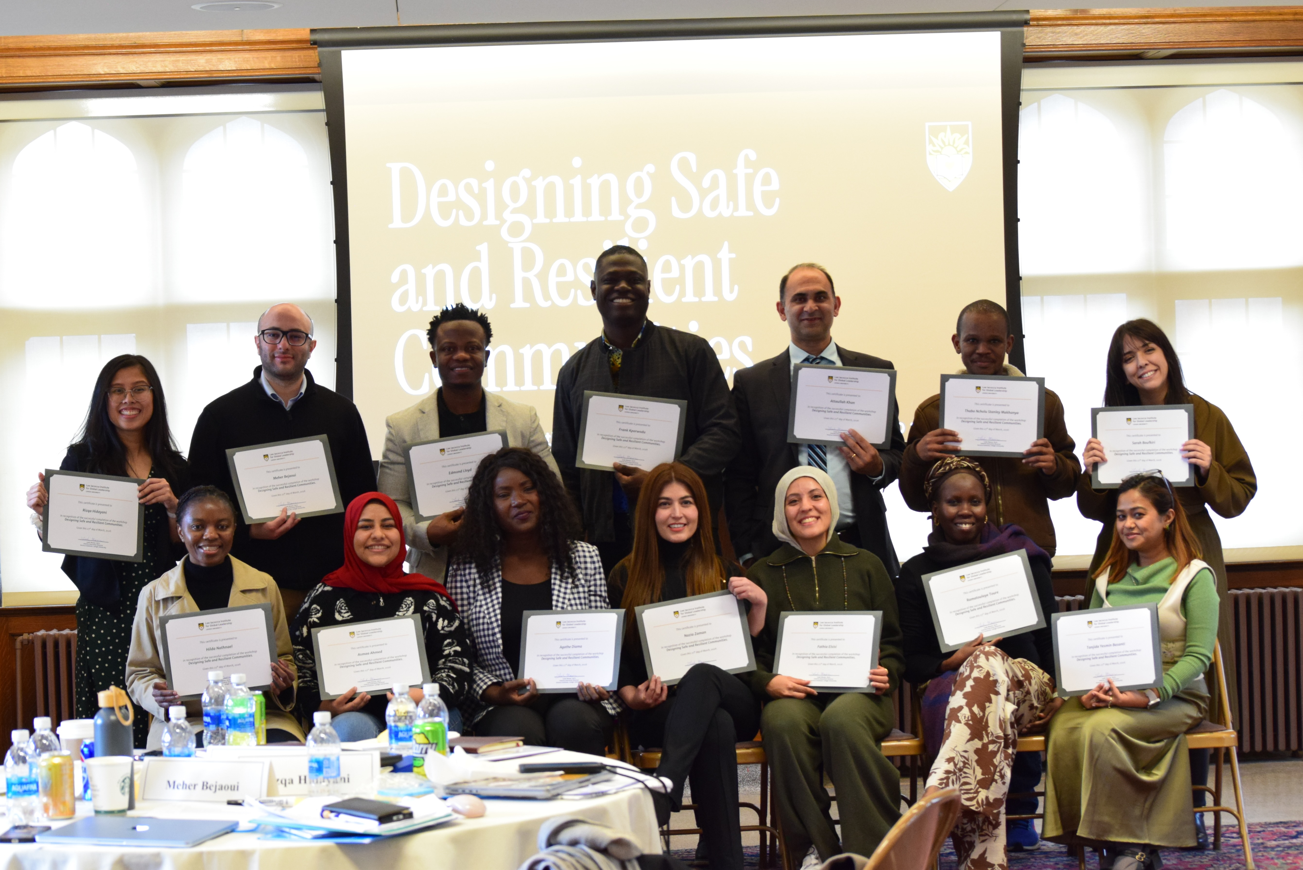 A group of people holding certificates and posing for a group photo