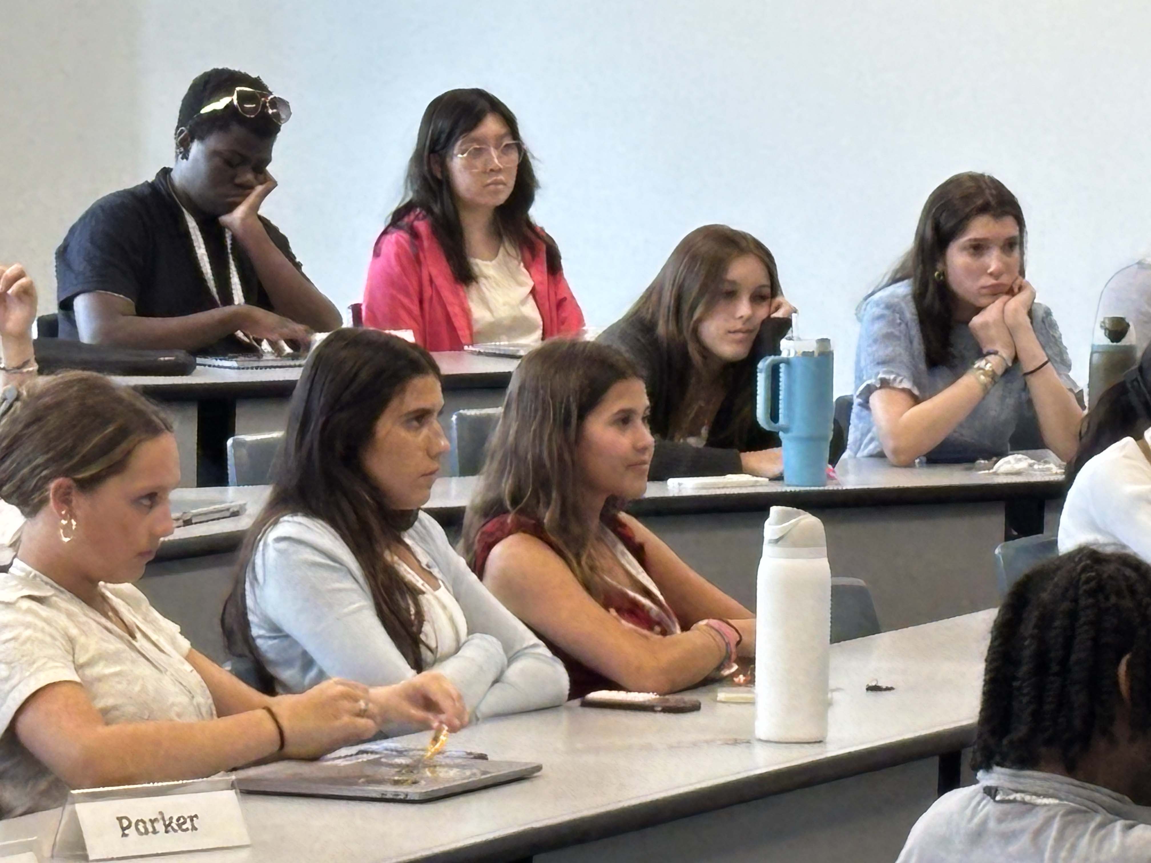 Several students sitting at tables in a classroom