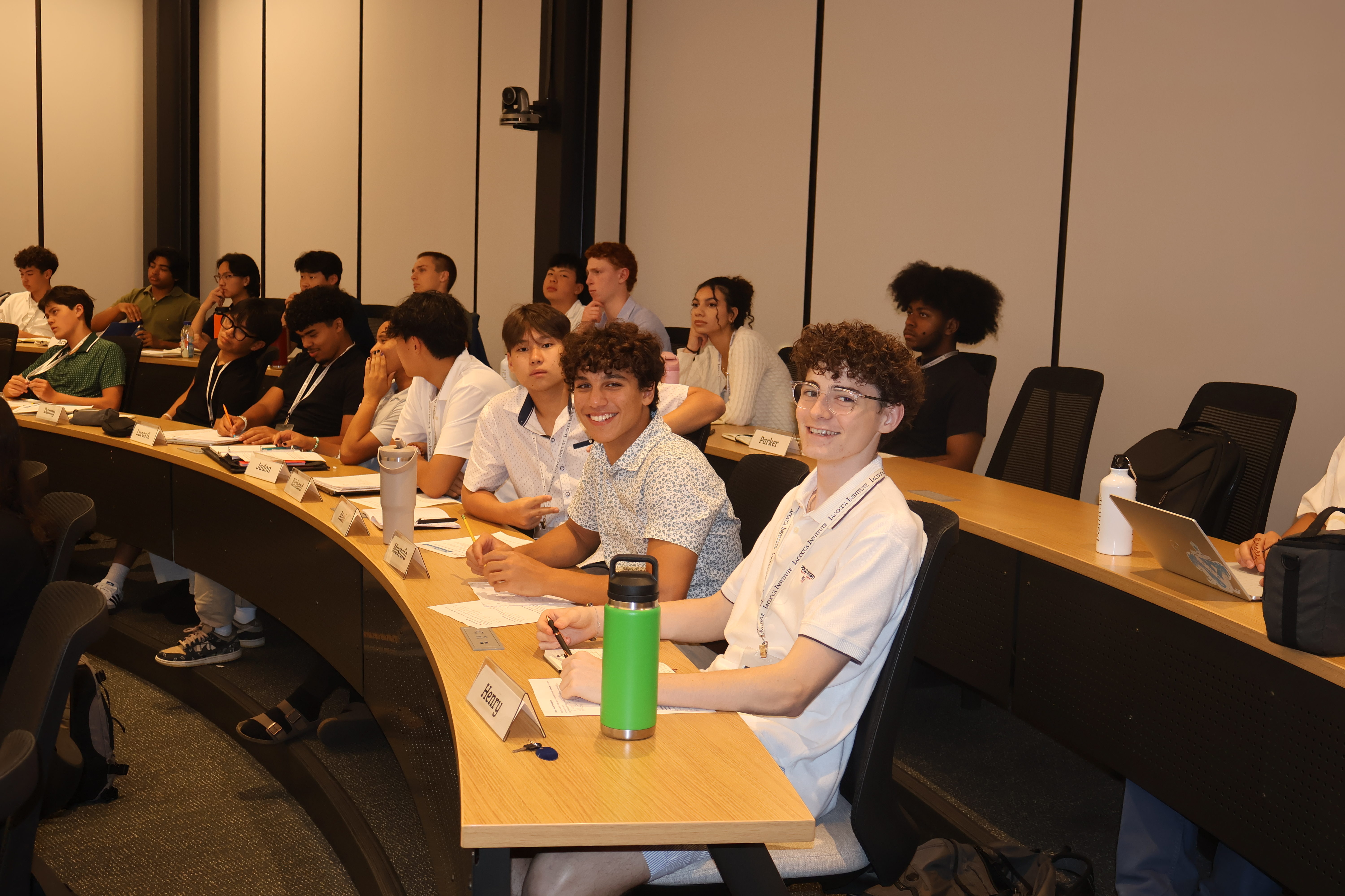 Students smiling in a lecture hall classroom