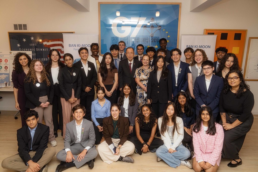 A group of people standing together and posing for a photo