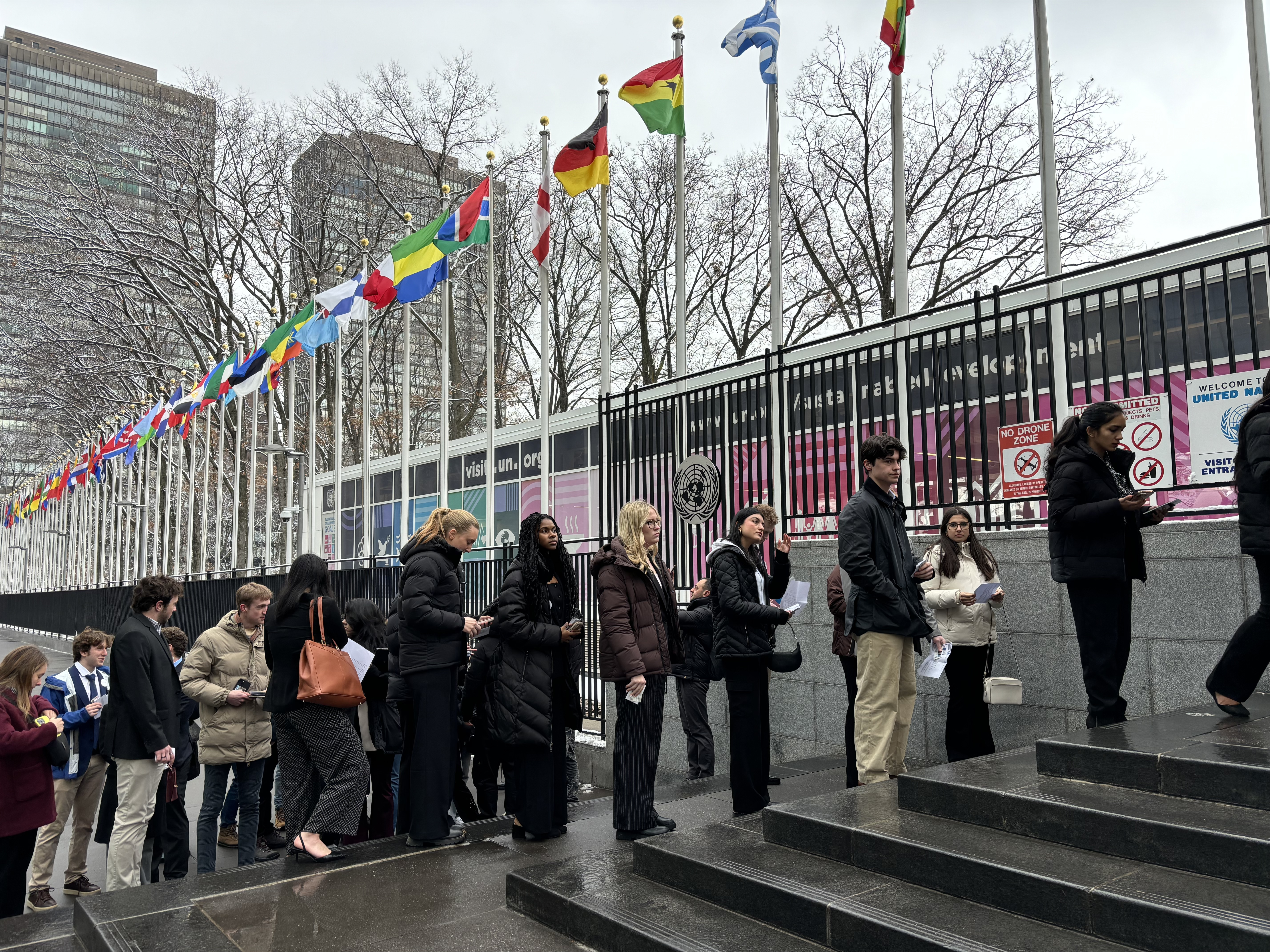 A group of young people in line outside the United Nations headquarters