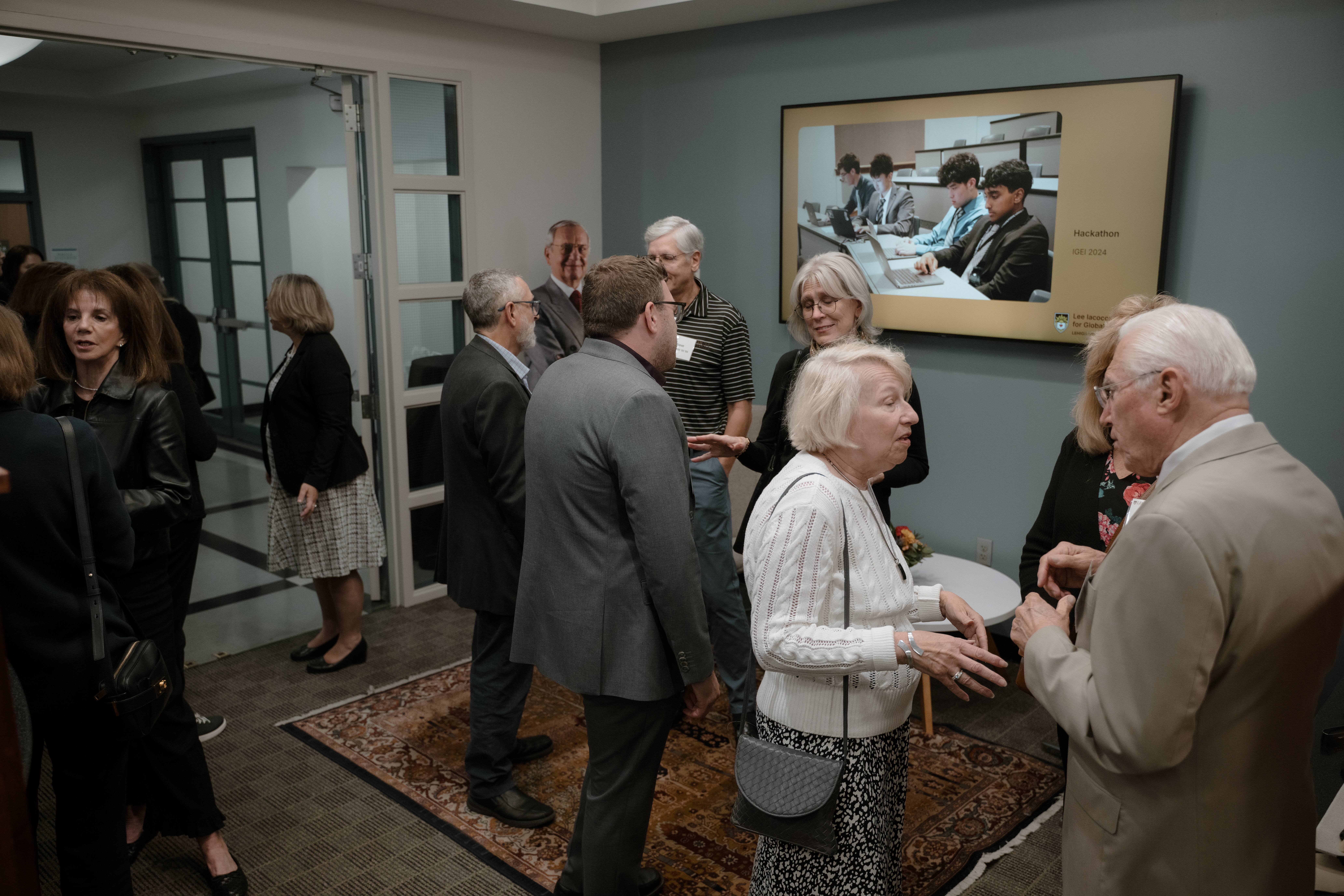 A group of people at an open house in an office setting
