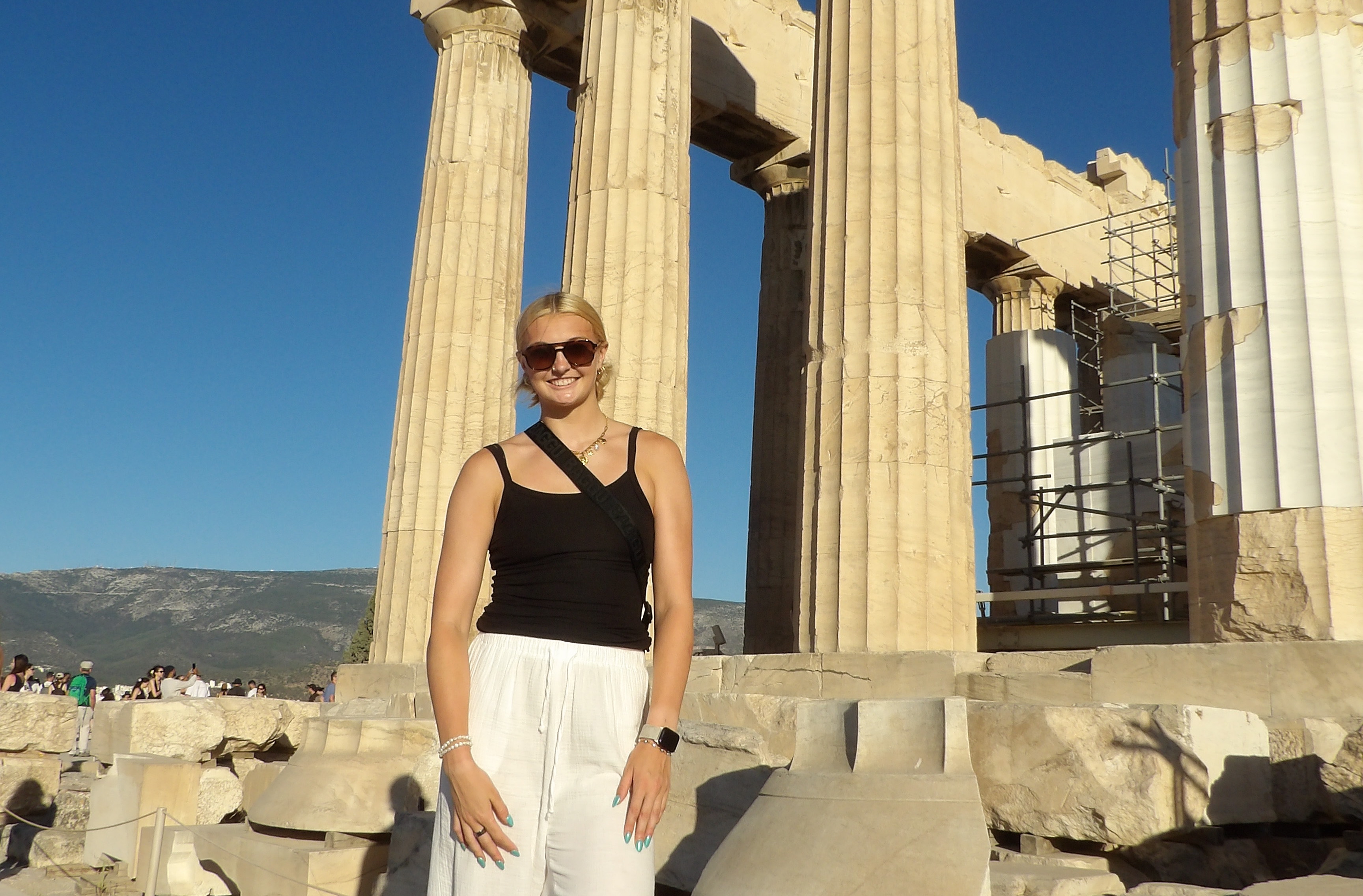 A college student in front of the Parthenon on the Acropolis of Athens, Greece