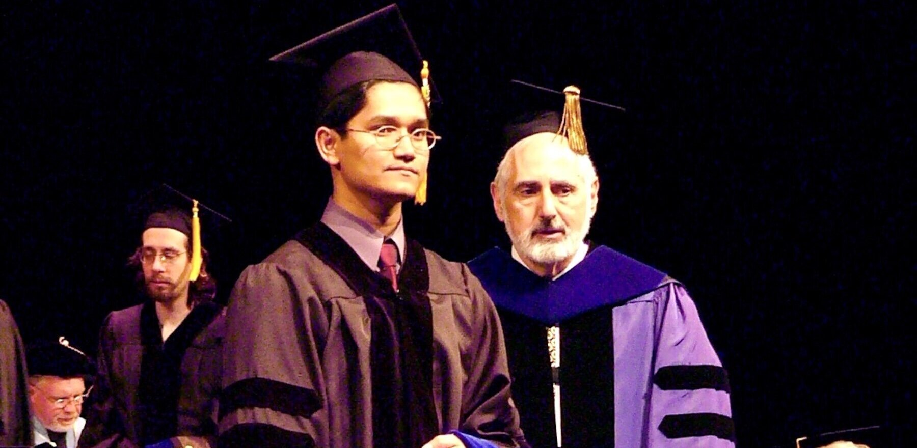 Man receiving diploma at PhD commencement