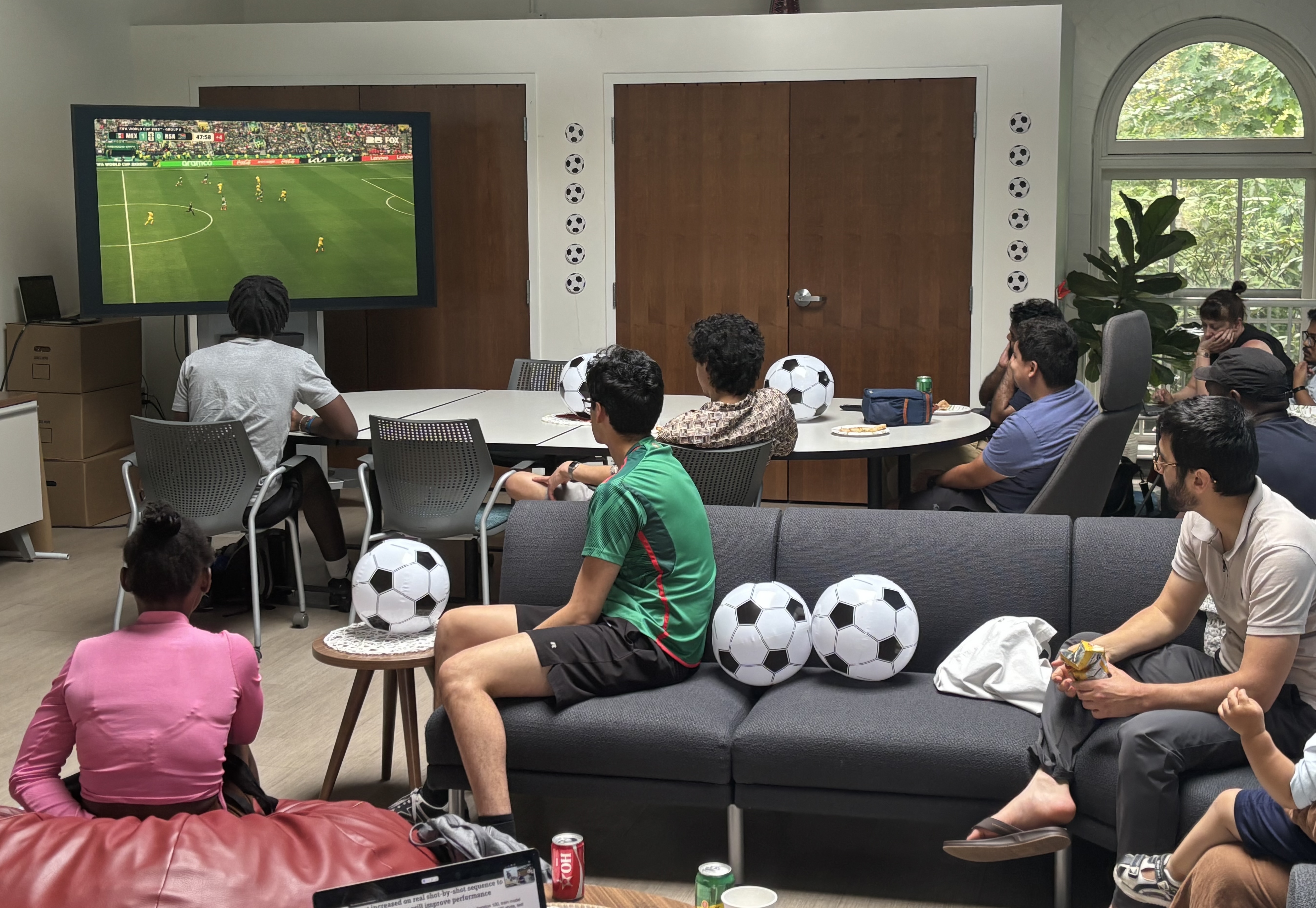 A group of people watching a World Cup match at a party