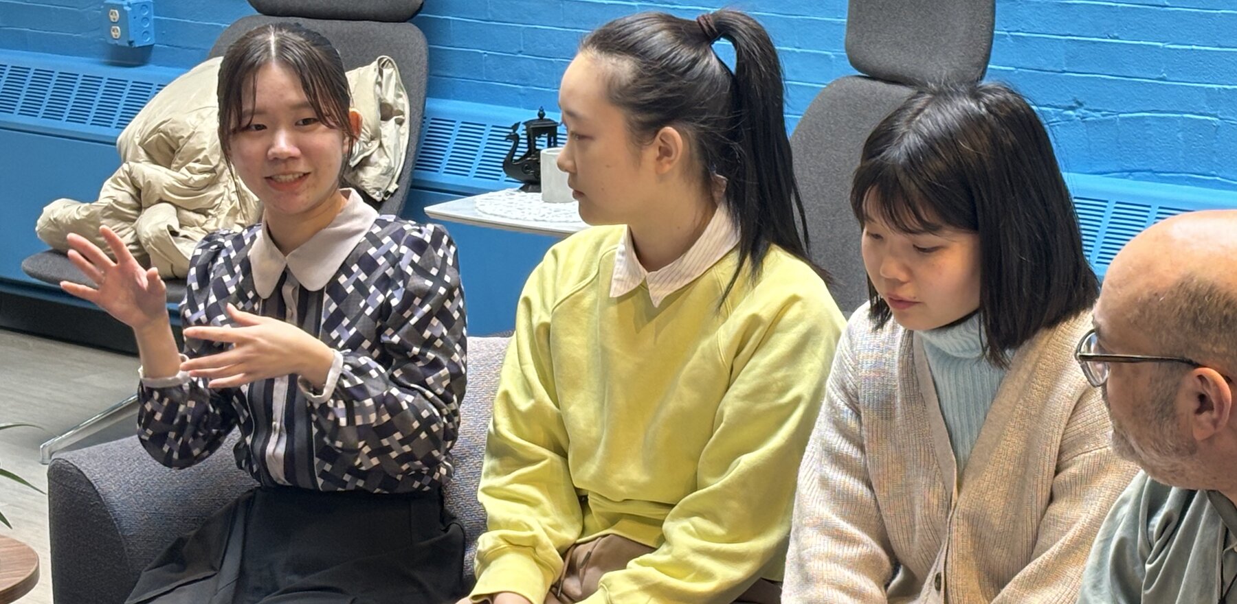 Three Japanese students speaking in a room at Lehigh University