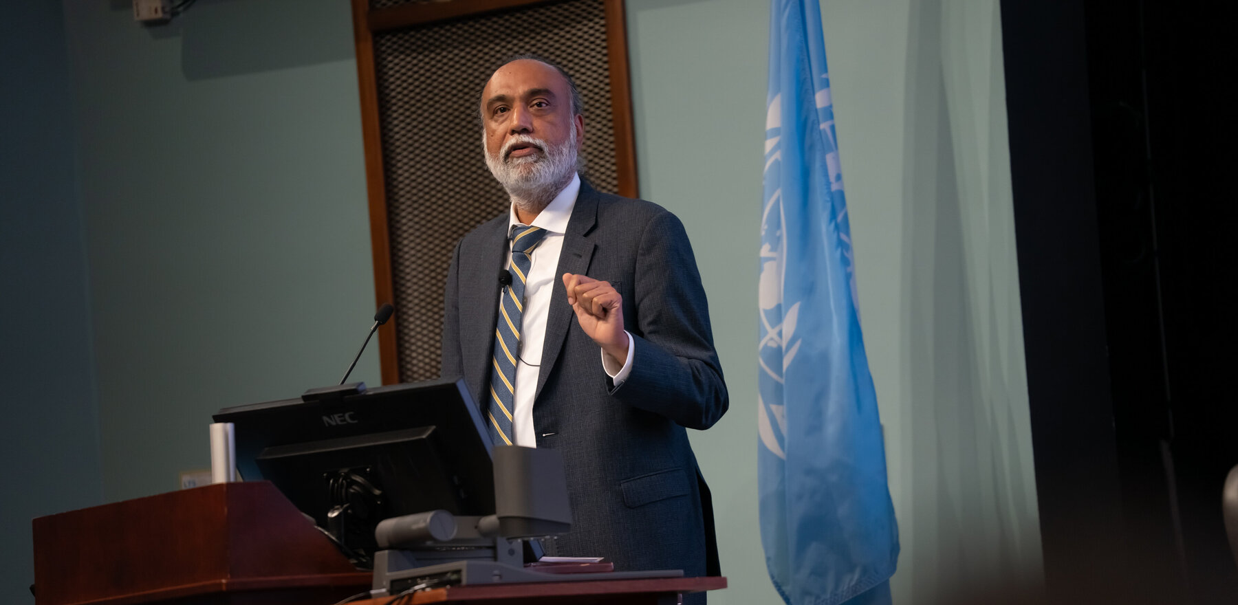 A man speaking at a podium on a stage