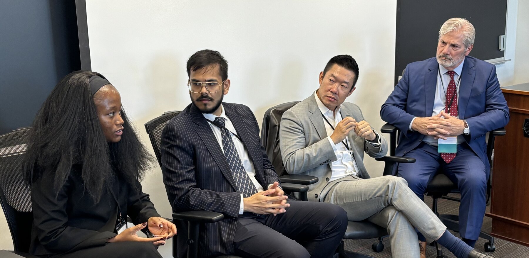 Four people speaking at a networking session