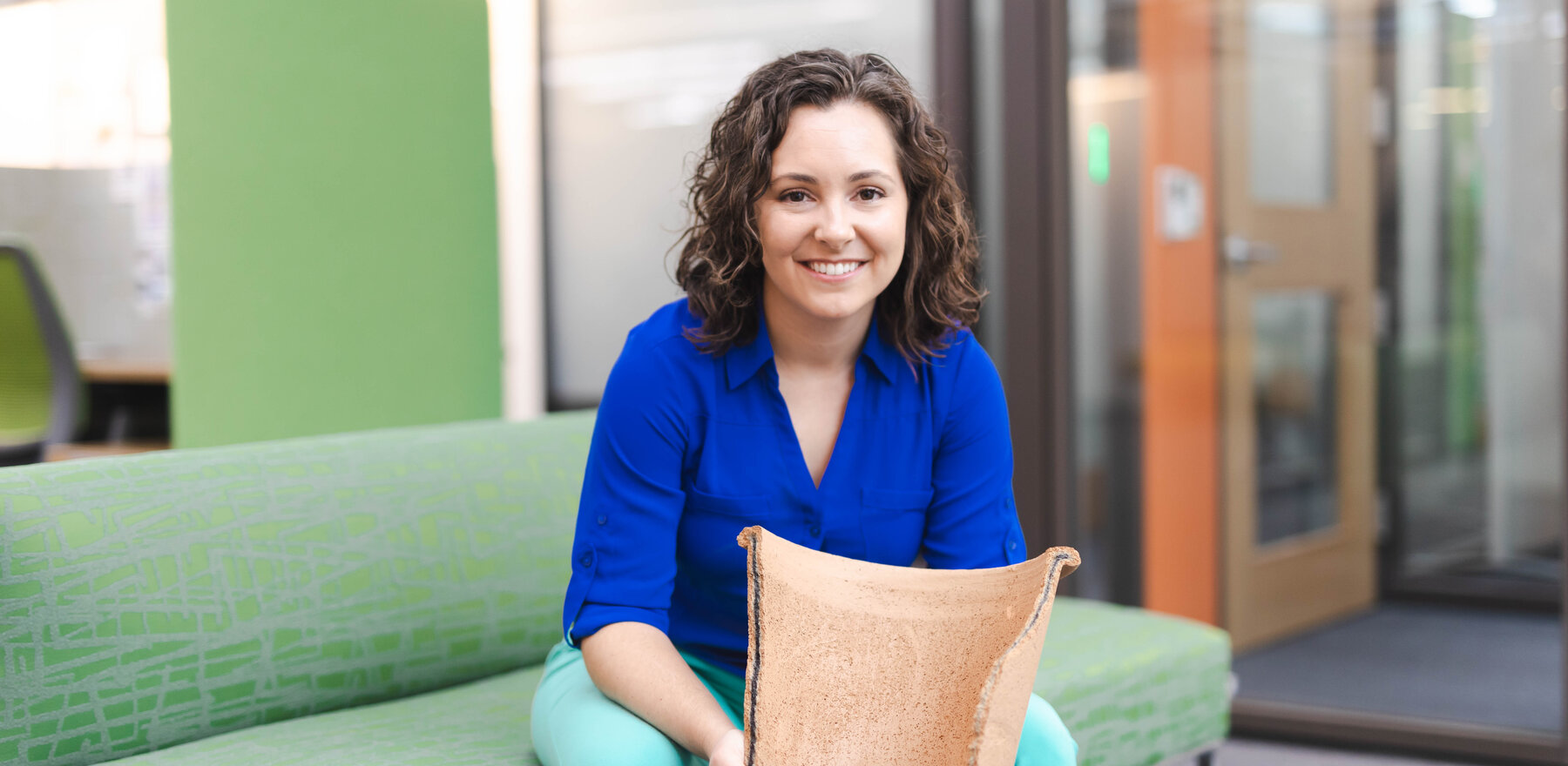 Gabrielle String sitting on a green couch