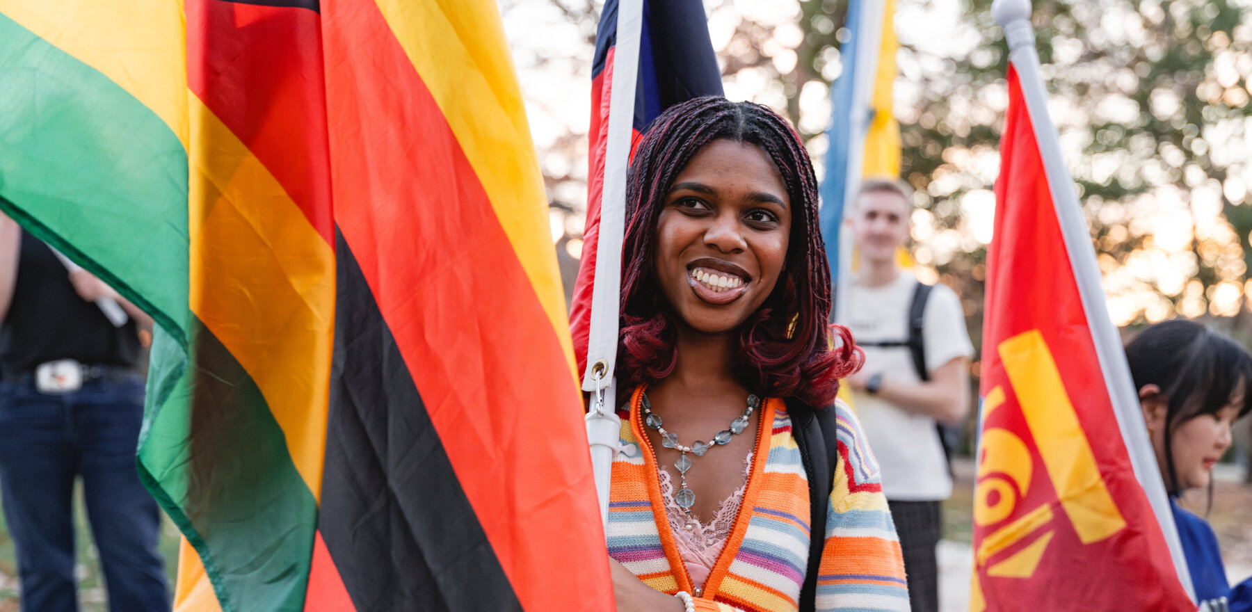 A young woman holding a flag during a parade