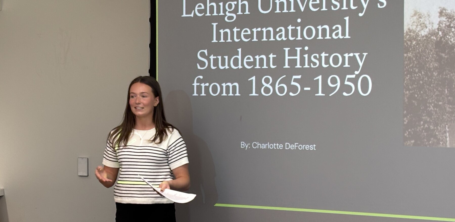 A young woman delivering a Powerpoint presentation