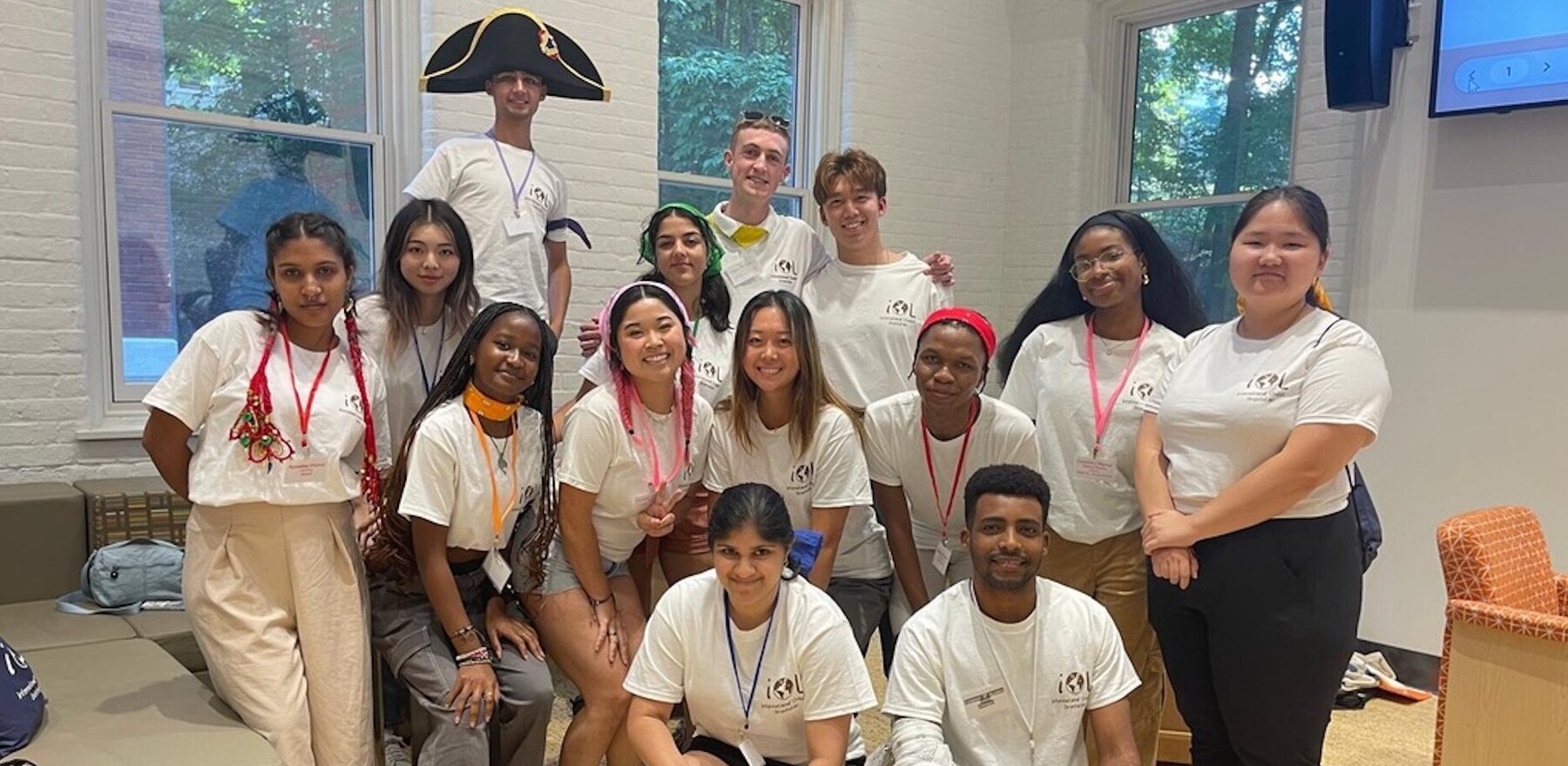 A group of students posing for a photo while wearing matching white t-shirts