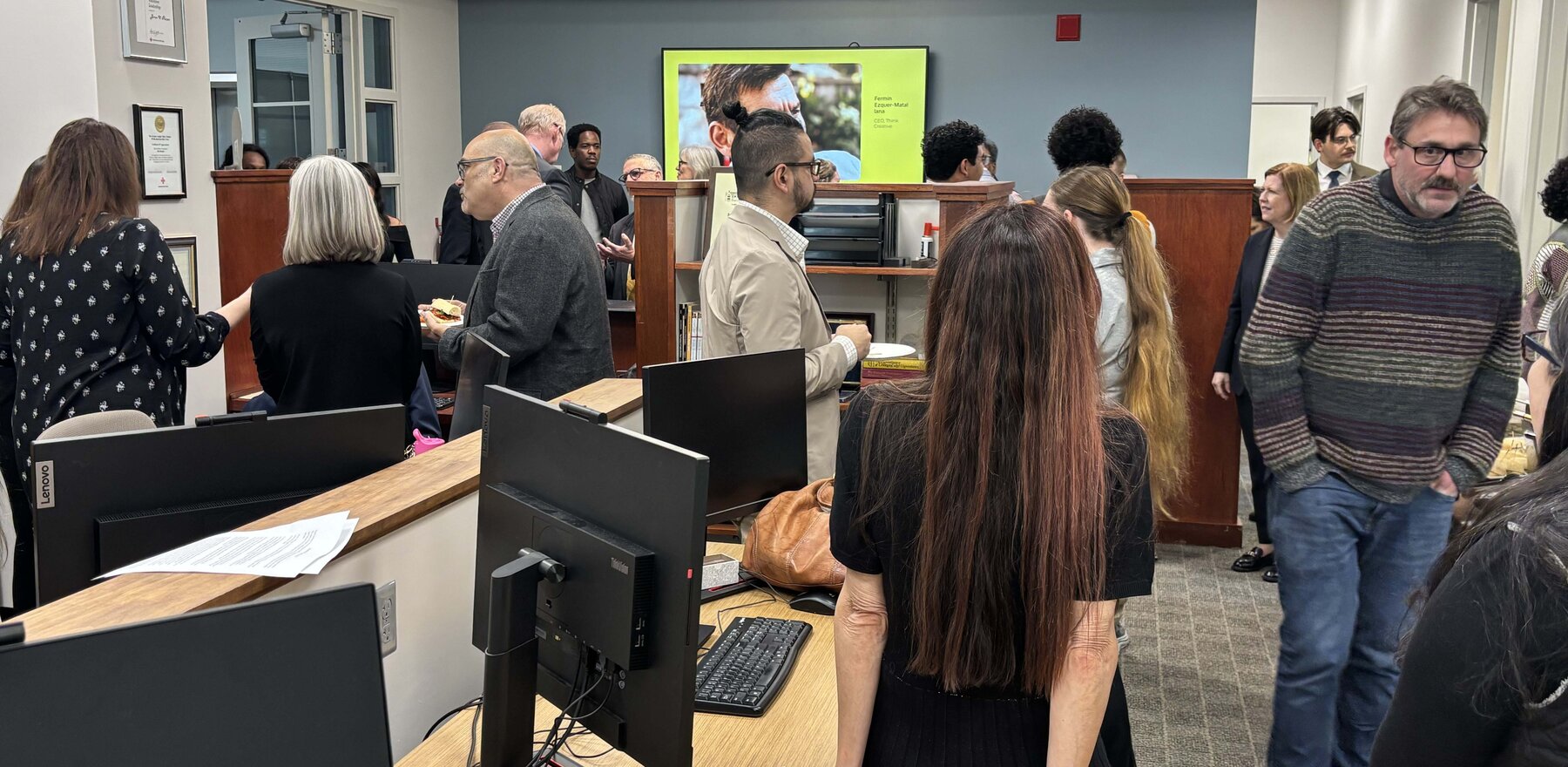A group of people in an office space for an open house
