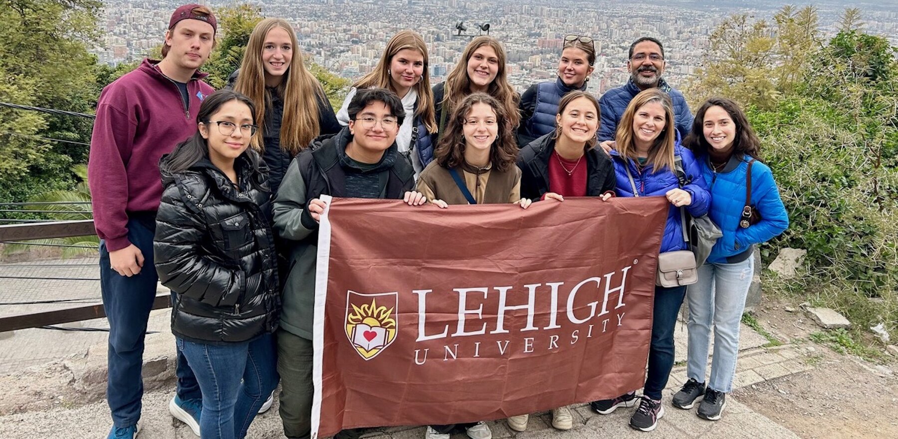 Lehigh students holding a university banner in front of a view of Chile