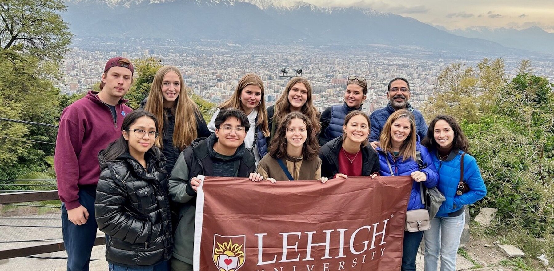 Lehigh students holding a university banner in front of a view of Chile