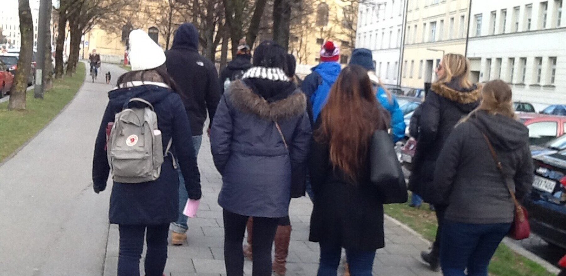 A group of college students walking down a street in Munich, Germany