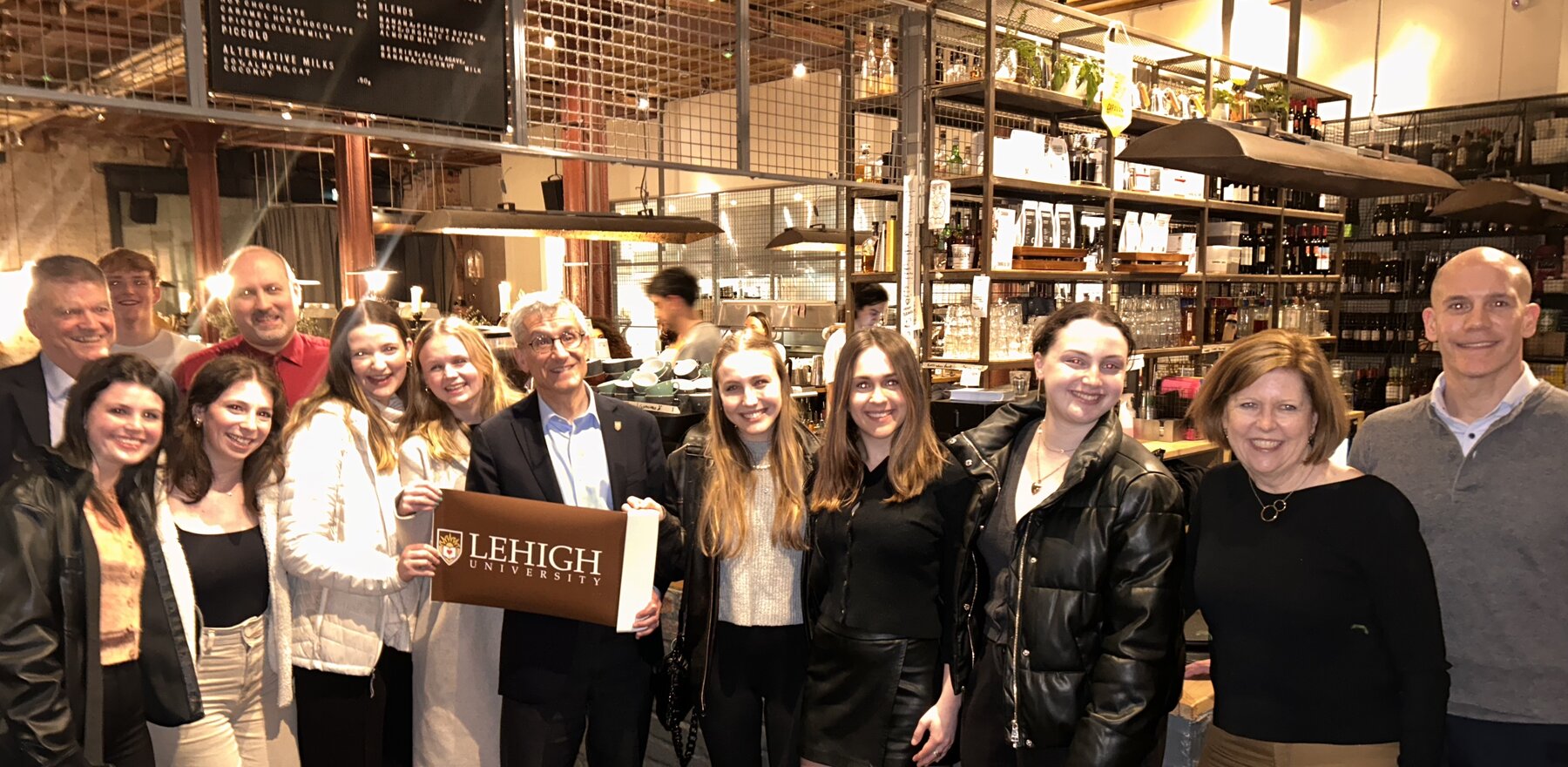 Lehigh University President Joseph Helble with students in a London restaurant