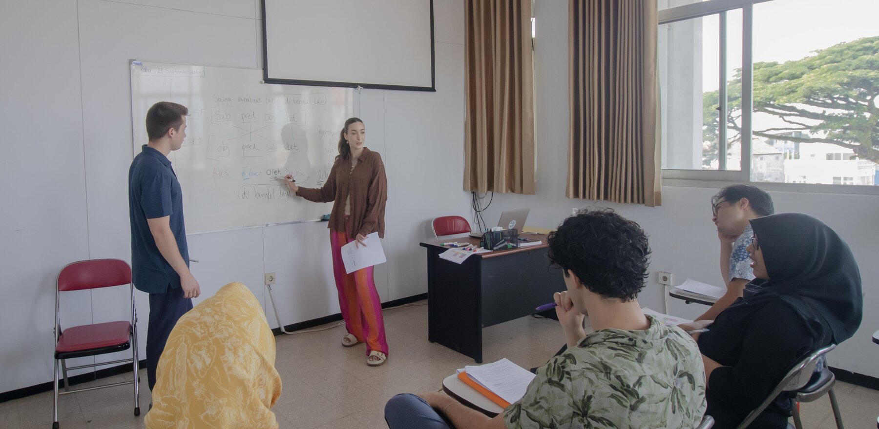 A woman speaking to a classroom of students