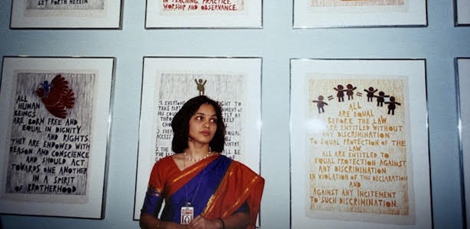 A woman standing in front of United Nations posters