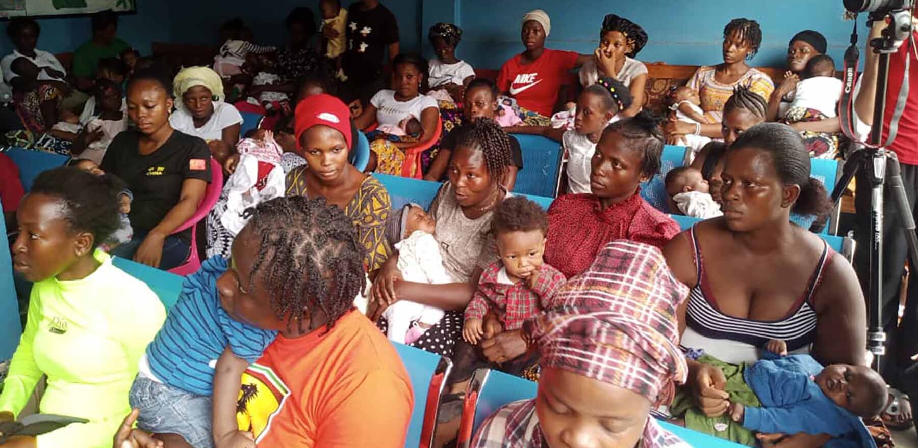 A group of people seated in a hospital conference room in Sierra Leone