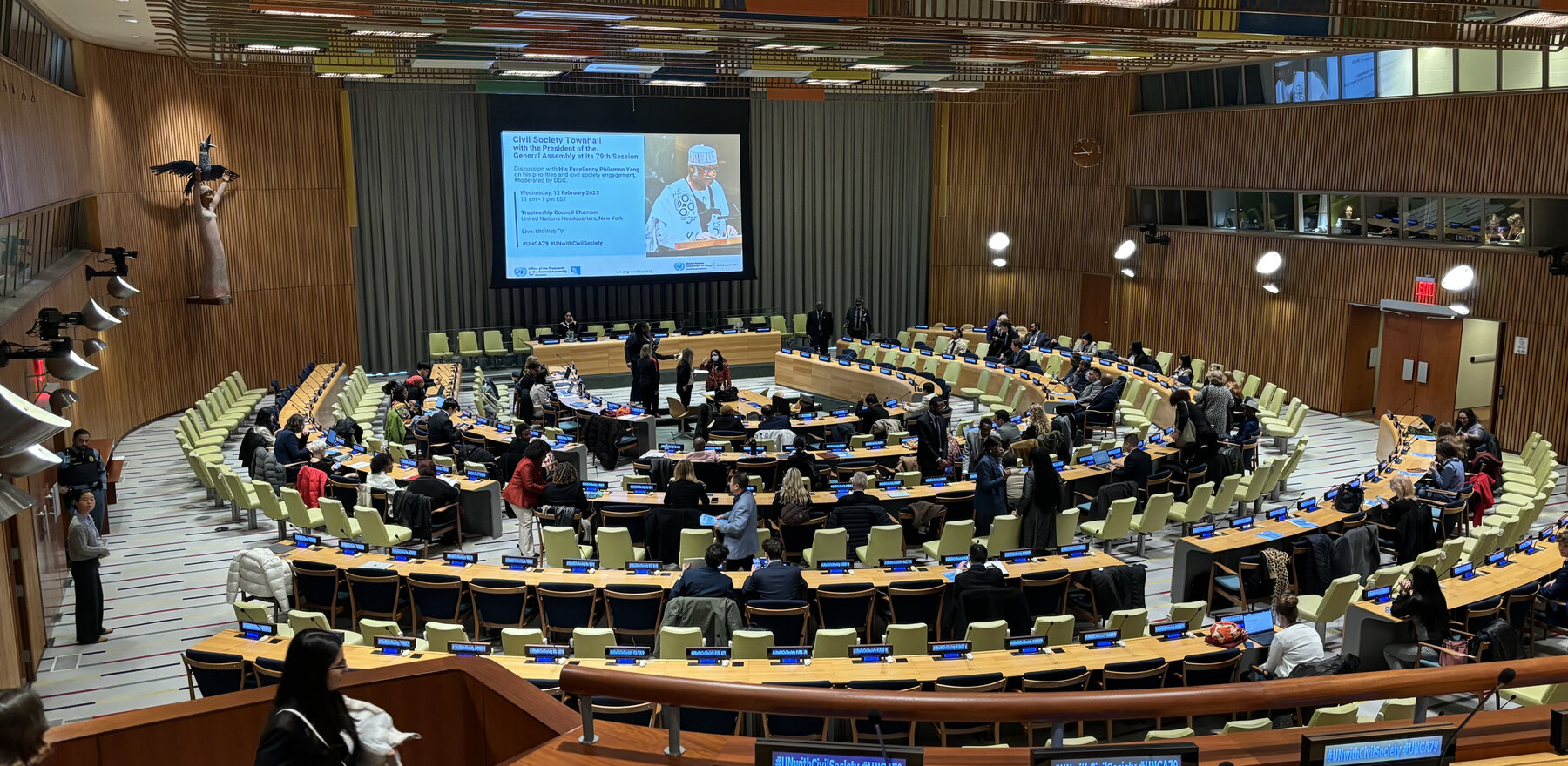 A crowd of people in a United Nations chamber