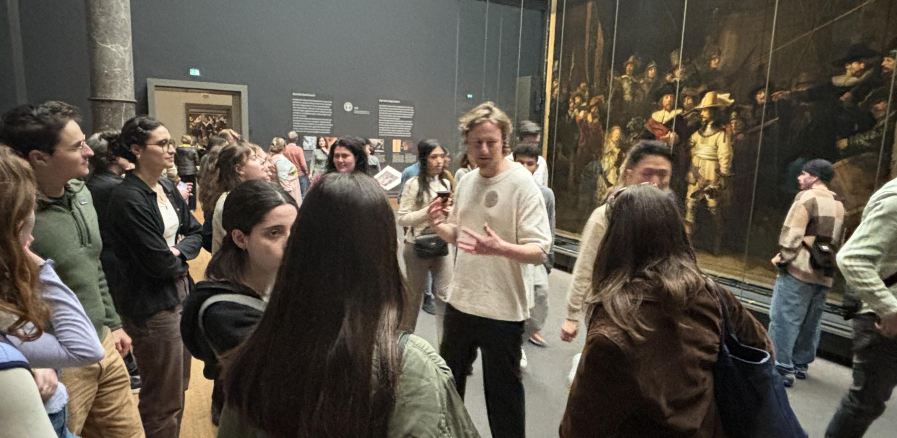 A professor speaking to students at the Rijksmuseum museum in Amsterdam