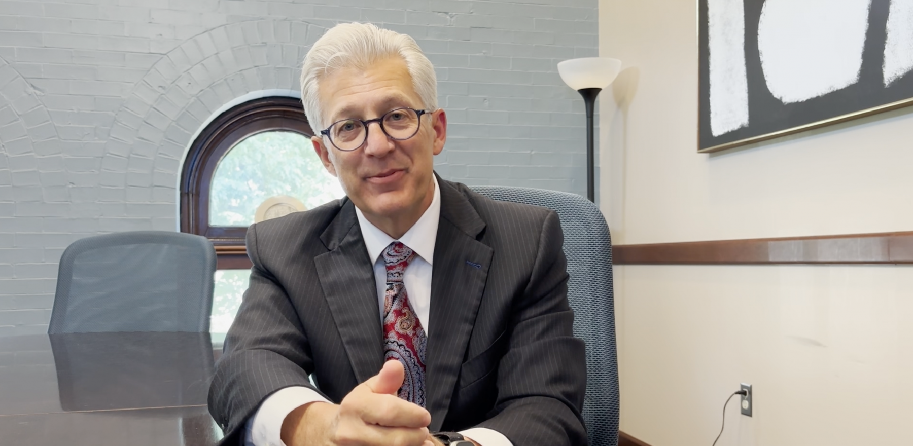 Scott Koerwer sitting in a chair in a conference room