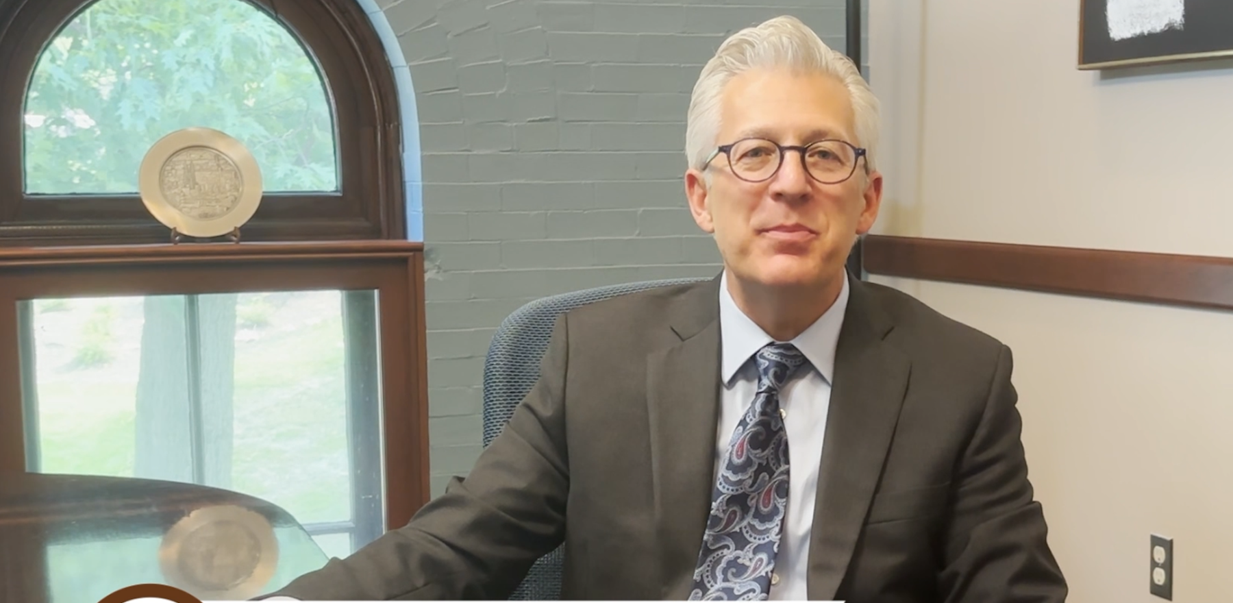 Scott Koerwer sitting in a chair in a conference room