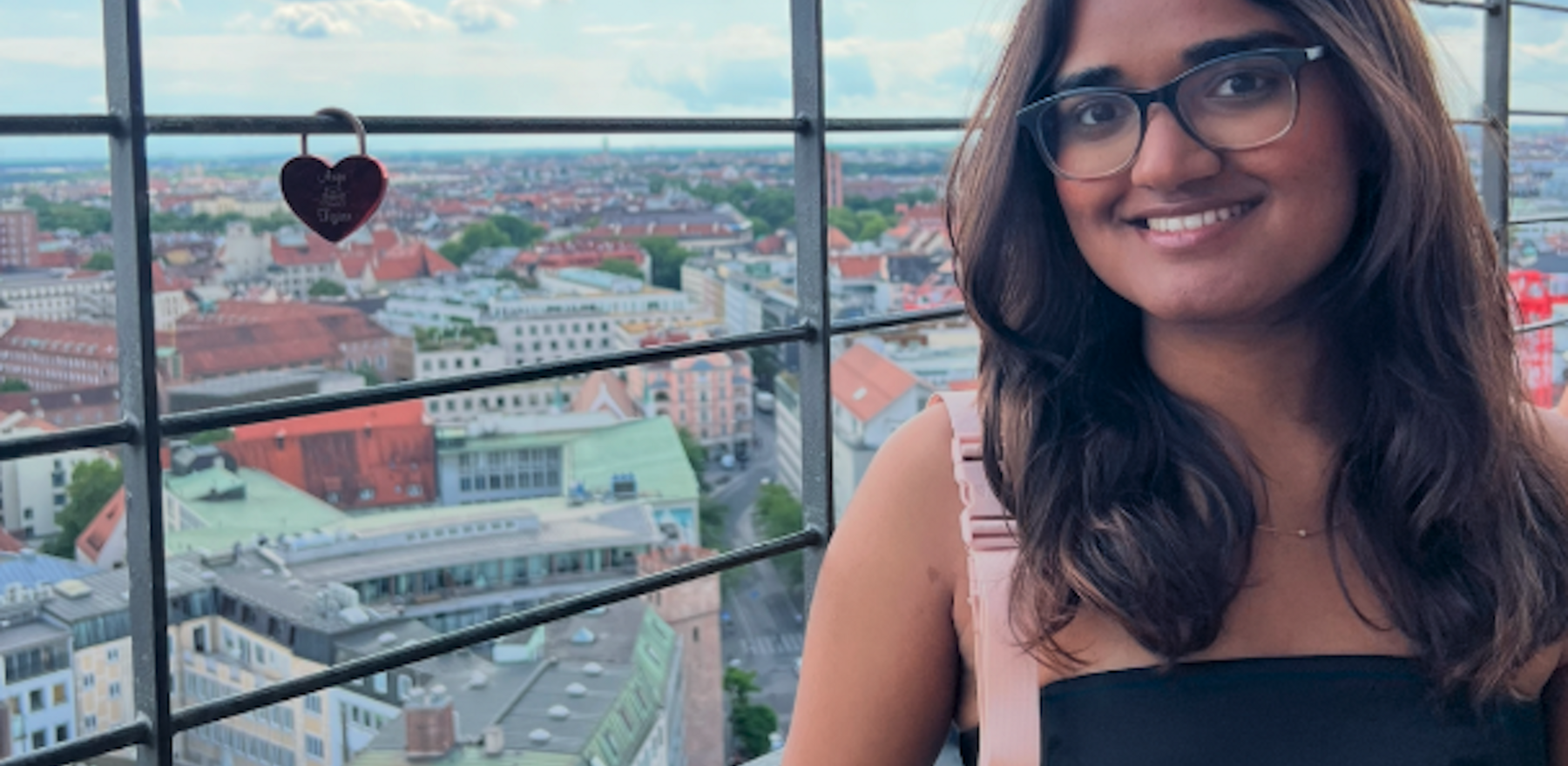 A young woman standing in front of a window in a tower