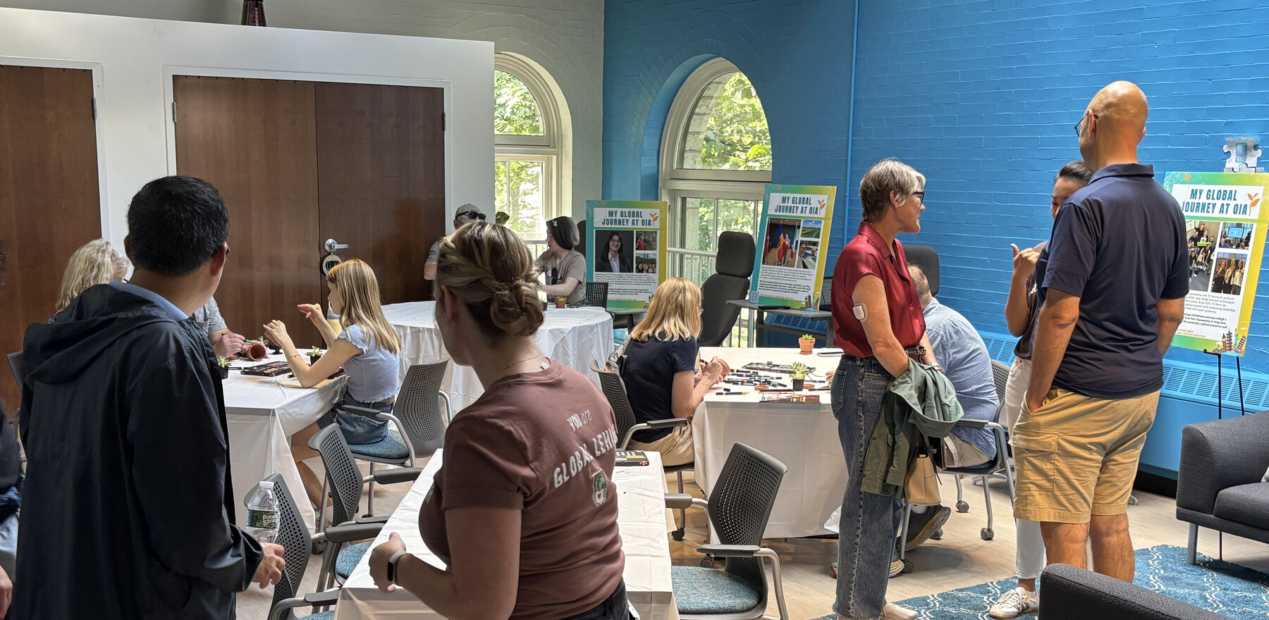 A group of people gathered in a community space with tables and chairs