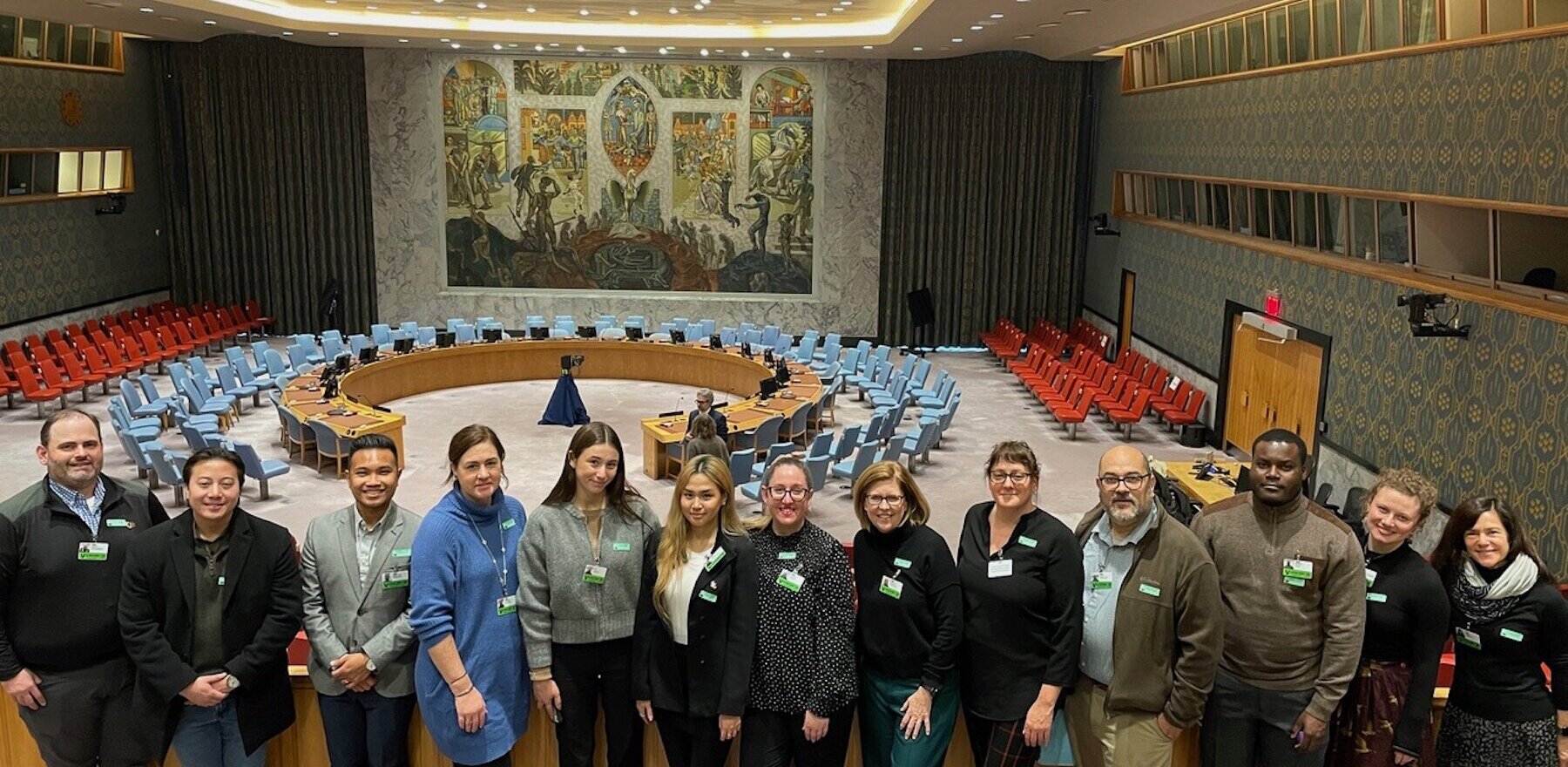 A group of people posing for a photo at the United Nations headquarters