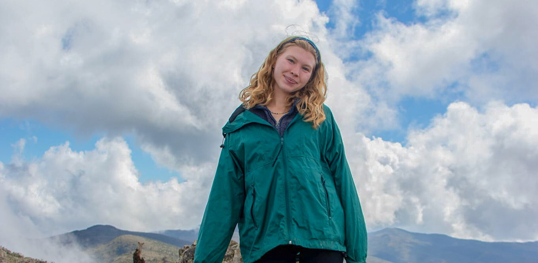 A student standing on a hill in Panama