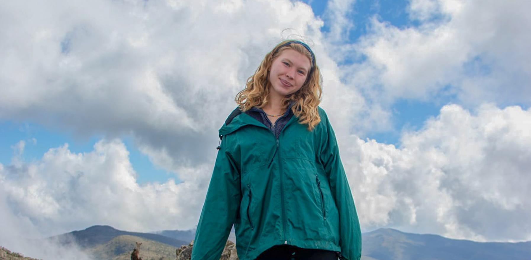 A student standing on a hill in Panama