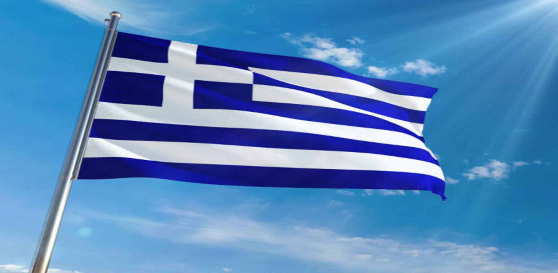 Flag of Greece flying in the blue sky