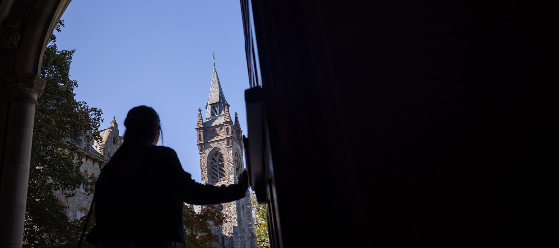 Silhouette of student walking out door