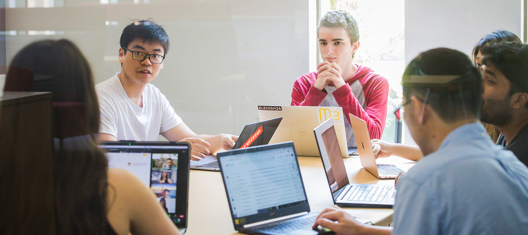 Students meet in a group to discuss their Inquiry to Impact project